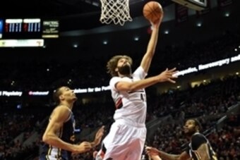 Apr 11, 2015; Portland, OR, USA; Portland Trail Blazers center Robin Lopez (42) goes up for a shot on Utah Jazz center Rudy Gobert (27) and forward Trevor Booker (33) during the first quarter of the game at Moda Center at the Rose Quarter. Mandatory Credi