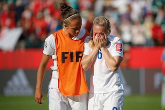 EDMONTON, AB - JULY 01:  Laura Bassett of England is comforted by Jo Potter after the FIFA Women's World Cup Semi Final match between Japan and England at the Commonwealth Stadium on July 1, 2015 in Edmonton, Canada.  (Photo by Kevin C. Cox/Getty Images)