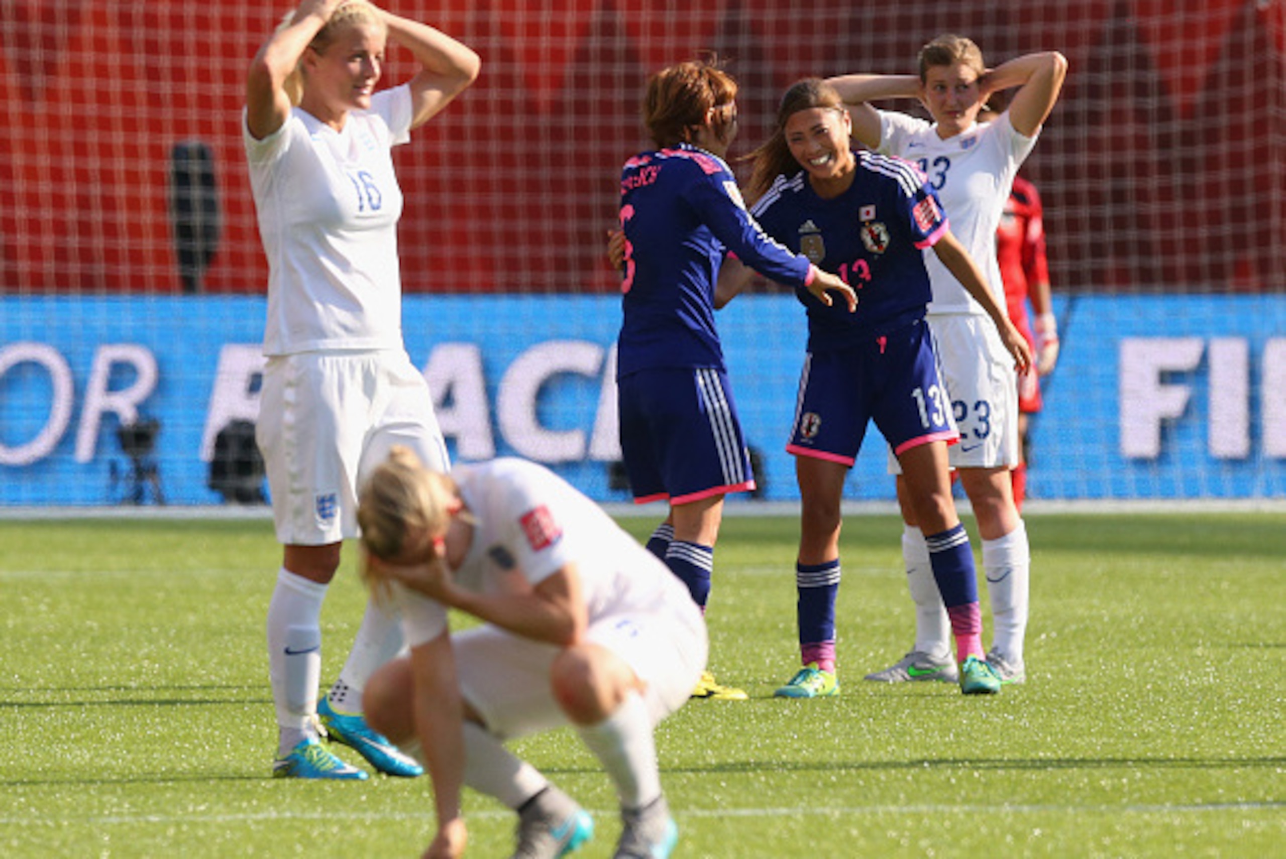 EDMONTON, AB - JULY 01:  Mizuho Sakaguchi and Rumi Utsugi of Japan celebrate after the FIFA Women's World Cup Semi Final match between Japan and England at the Commonwealth Stadium on July 1, 2015 in Edmonton, Canada.  (Photo by Ronald Martinez/Getty Imag