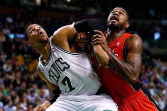 BOSTON, MA - JANUARY 15: Jared Sullinger #7 of the Boston Celtics and Amir Johnson #15 of the Toronto Raptors battle for position underneath the basket in the second half during the game at TD Garden on January 15, 2014 in Boston, Massachusetts. NOTE TO U