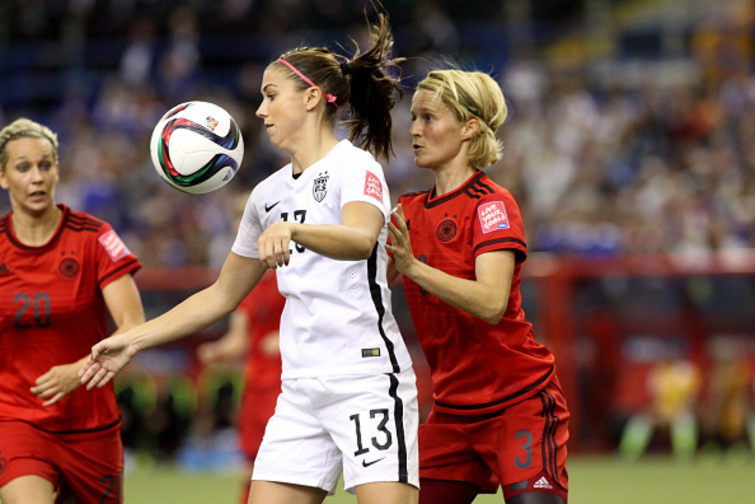 MONTREAL, QC - JUNE 30:  Alex Morgan #13 of the United States with the ball against Saskia Bartusiak #3 of Germany in the first half in the FIFA Women's World Cup 2015 Semi-Final Match at Olympic Stadium on June 30, 2015 in Montreal, Canada.  (Photo by Fr