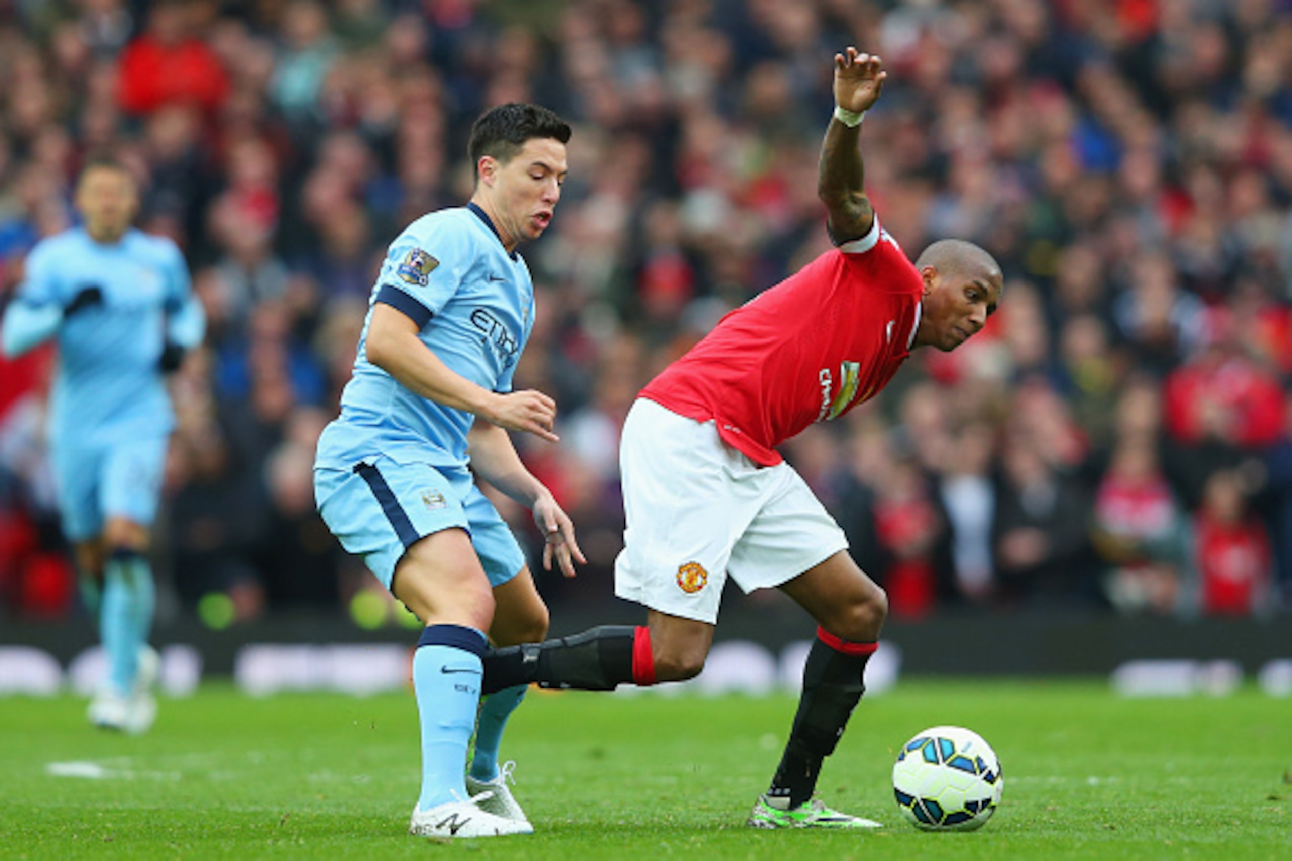 MANCHESTER, ENGLAND - APRIL 12:  Ashley Young of Manchester United evades Samir Nasri of Manchester City during the Barclays Premier League match between Manchester United and Manchester City at Old Trafford on April 12, 2015 in Manchester, England.  (Pho