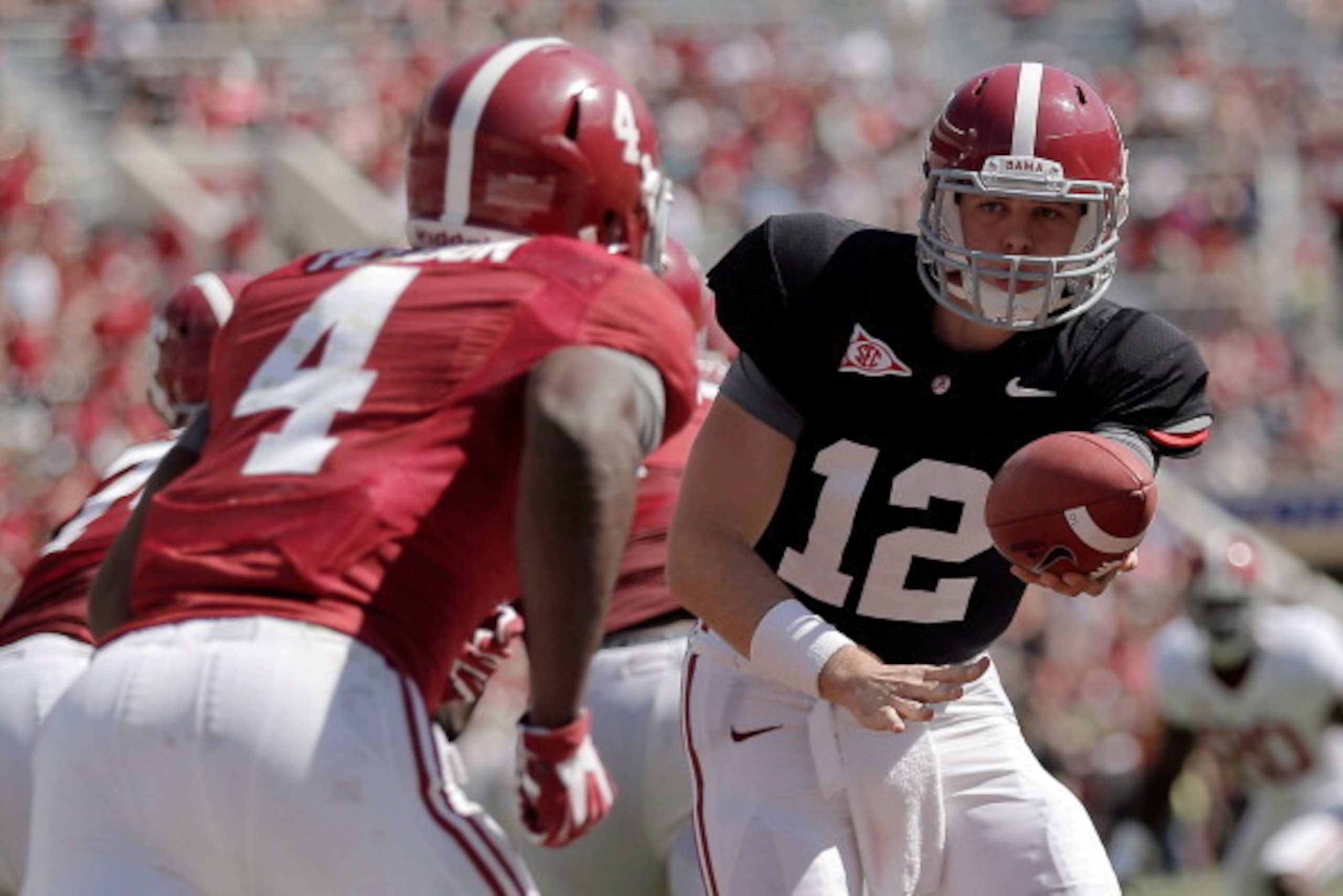 TUSCALOOSA, AL - APRIL 19:  David Cornwell #12 of the Crimson team looks to hand the ball to T.J. Yeldon #4 during the University of Alabama A-Day spring game at Bryant-Denny Stadium on April 19, 2014 in Tuscaloosa, Alabama.  (Photo by Stacy Revere/Getty 