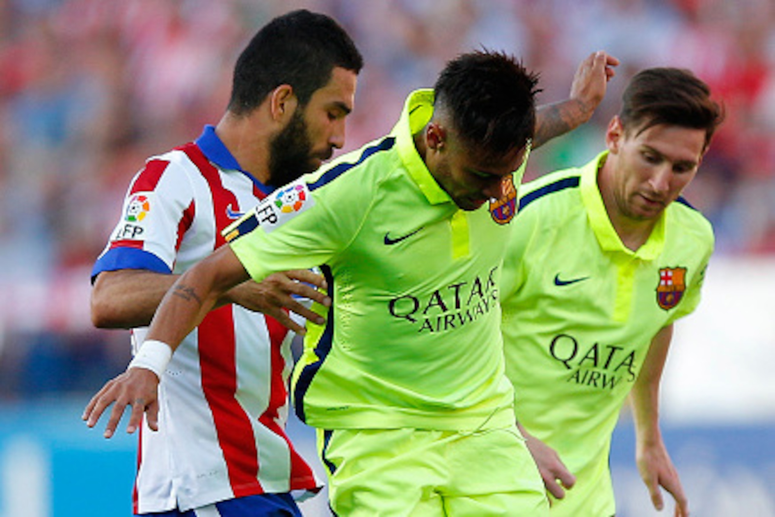 MADRID, SPAIN - MAY 17: Arda Turan of Atletico Madrid battles with Neymar and Lionel Messi of Barcelona during the La Liga match between Club Atletico de Madrid and FC Barcelona at Vicente Calderon Stadium on May 17, 2015 in Madrid, Spain. (Photo by Gon MADRID, SPAIN - MAY 17: Arda Turan of Atletico Madrid battles with Neymar and Lionel Messi of Barcelona during the La Liga match between Club Atletico de Madrid and FC Barcelona at Vicente Calderon Stadium on May 17, 2015 in Madrid, Spain. (Photo by Gon