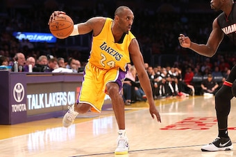LOS ANGELES, CA - JANUARY 13:  Kobe Bryant #24 of the Los Angeles Lakers controls the ball against Luol Deng #9 of the Miami Heat at Staples Center on January 13, 2015 in Los Angeles, California.  NOTE TO USER: User expressly acknowledges and agrees that,