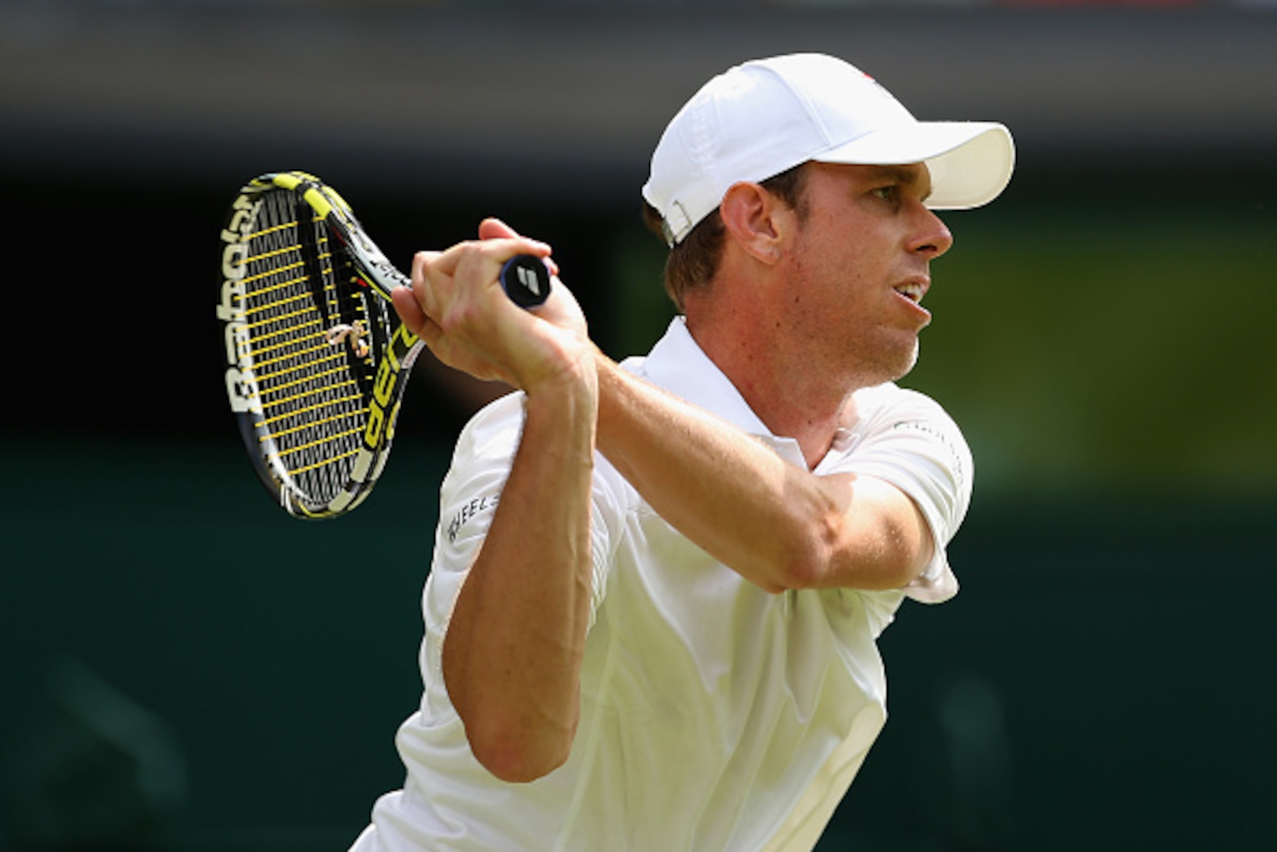 LONDON, ENGLAND - JULY 02: Sam Querry of the United States plays a backhand during his Gentlemens Singles Second Round match against Roger Federer of Switzerland during day four of the Wimbledon Lawn Tennis Championships at the All England Lawn Tennis an LONDON, ENGLAND - JULY 02: Sam Querry of the United States plays a backhand during his Gentlemens Singles Second Round match against Roger Federer of Switzerland during day four of the Wimbledon Lawn Tennis Championships at the All England Lawn Tennis an