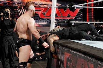 Sheamus moves in to attack Roman Reigns.