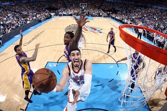 OKLAHOMA CITY, OK- MARCH 24: Enes Kanter #34 of the Oklahoma City Thunder shoots against the Los Angeles Lakers on March 24, 2014 at Chesapeake Energy Arena in Oklahoma City, OK. NOTE TO USER: User expressly acknowledges and agrees that, by downloading an