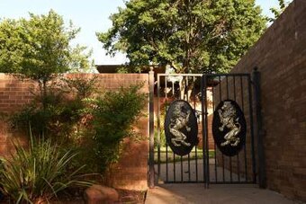 A chained gate to SAE's now-vacant fraternity house.