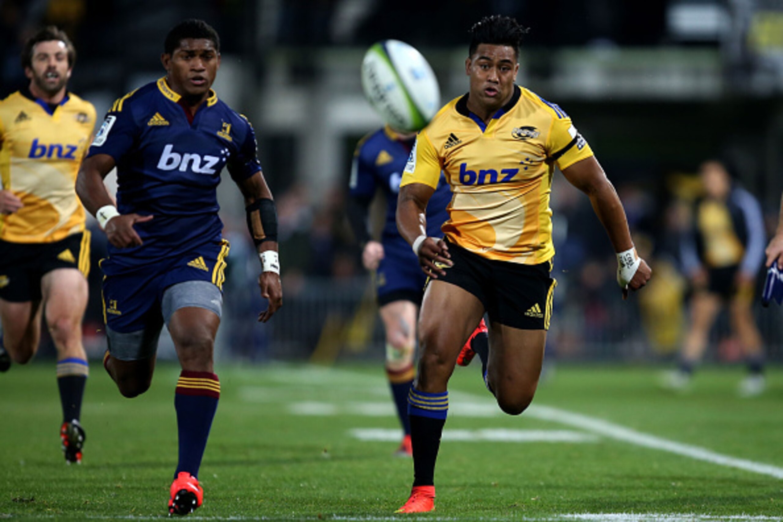 NAPIER, NEW ZEALAND - JUNE 05: Julian Savea of the Hurricanes (right) and Waisake Naholo of the Highlanders chase after the ball during the round 17 Super Rugby match between the Hurricanes and the Highlanders at McLean Park on June 5, 2015 in Napier, Ne NAPIER, NEW ZEALAND - JUNE 05: Julian Savea of the Hurricanes (right) and Waisake Naholo of the Highlanders chase after the ball during the round 17 Super Rugby match between the Hurricanes and the Highlanders at McLean Park on June 5, 2015 in Napier, Ne