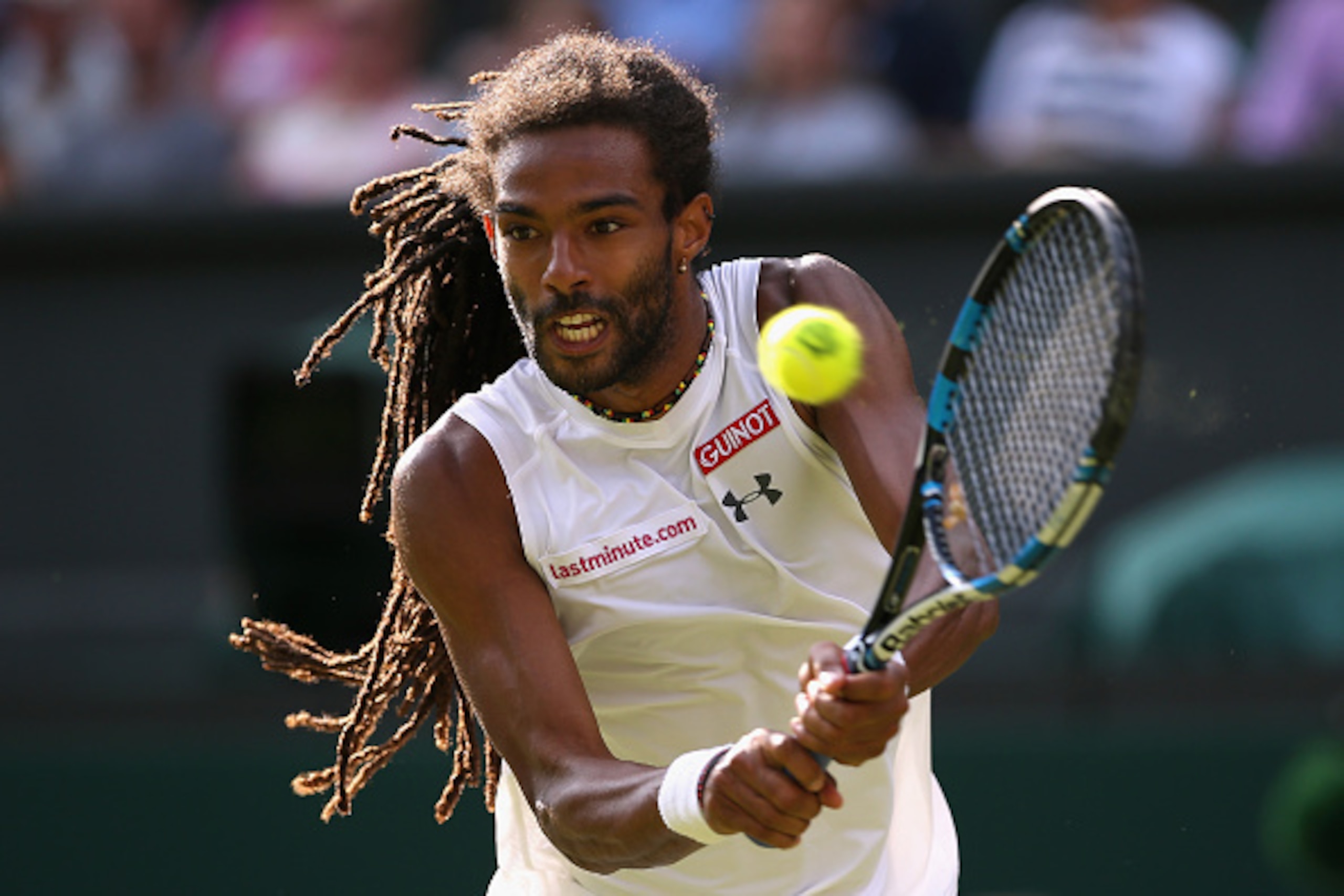 LONDON, ENGLAND - JULY 02:  Dustin Brown of Germany plays a backhand in his Gentlemens Singles Second Round match against Rafael Nadal of Spain during day four of the Wimbledon Lawn Tennis Championships at the All England Lawn Tennis and Croquet Club on J