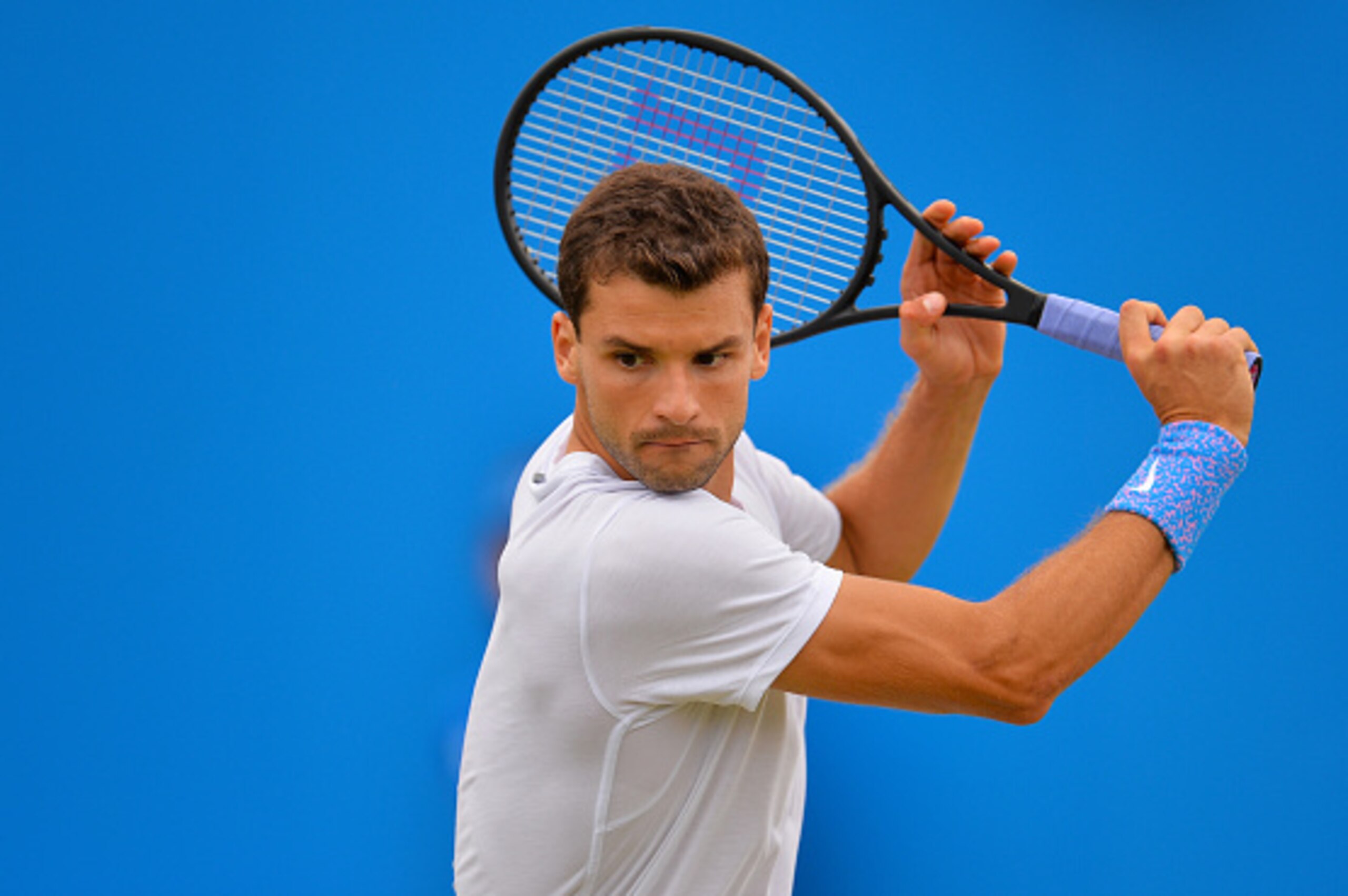 LONDON, ENGLAND - JUNE 17:  Grigor Dimitrov of Bulgaria partnering Stan Wawrinka of Switzerland, in the Men's doubles match against Marcin Matkowski of Poland and Nenad Zimonjic of Serbia during day three of the Aegon Championships at Queen's Club on June