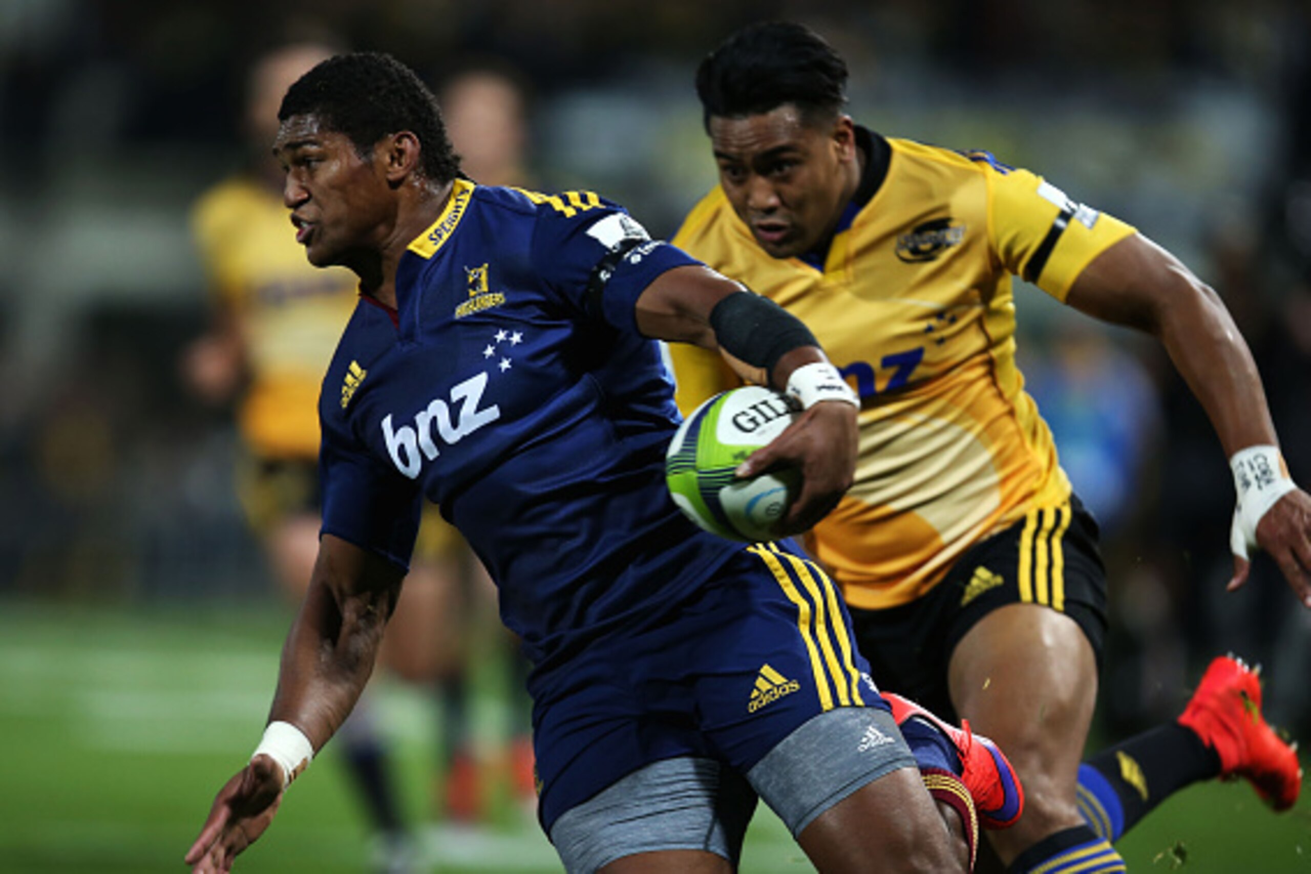NAPIER, NEW ZEALAND - JUNE 05:  Waisake Naholo of the Highlanders (left) tries to escape the oncoming Julian Savea of the Hurricanes (right)  chase after the ball during the round 17 Super Rugby match between the Hurricanes and the Highlanders at McLean P