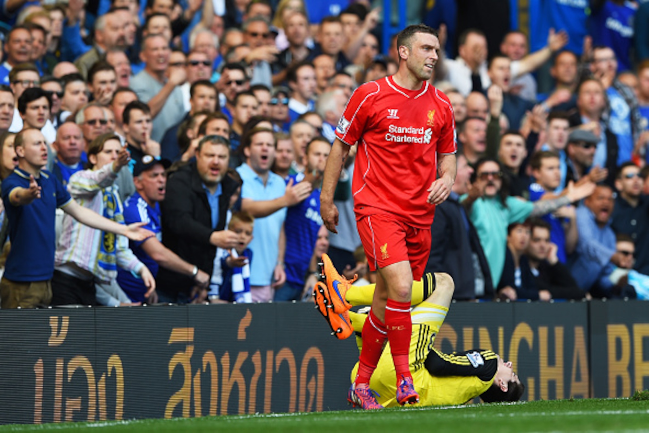 LONDON, ENGLAND - MAY 10:  Rickie Lambert of Liverpool is haranged by the chelsea fans after colliding with Thibaut Courtois of Chelsea during the Barclays Premier League match between Chelsea and Liverpool at Stamford Bridge on May 10, 2015 in London, En