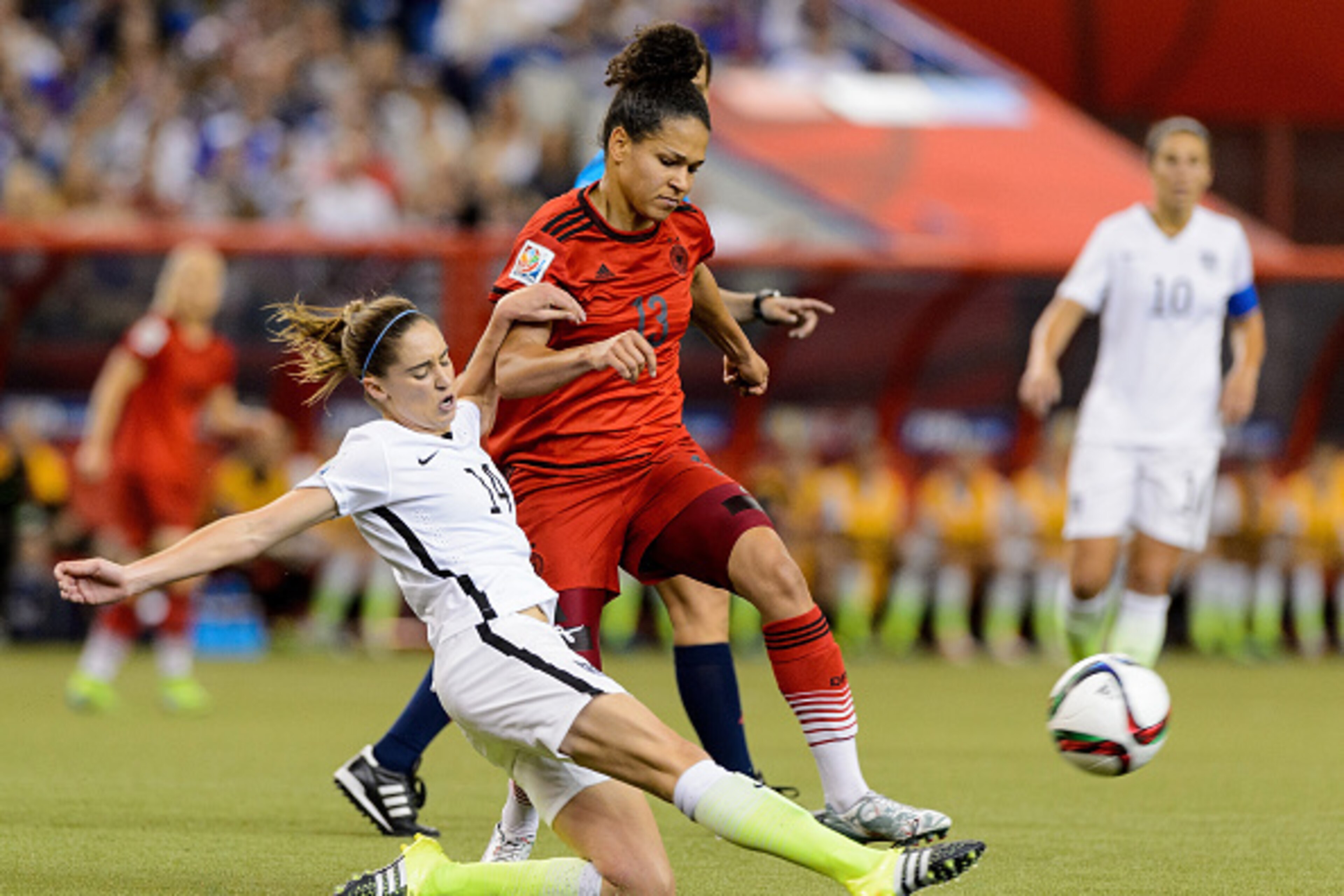 MONTREAL, QC - JUNE 30:  Morgan Brian #14 of the United States kicks the ball away from Celia Sasic #13 of Germany in the first half in the FIFA Women's World Cup 2015 Semi-Final Match at Olympic Stadium on June 30, 2015 in Montreal, Canada.  (Photo by Mi