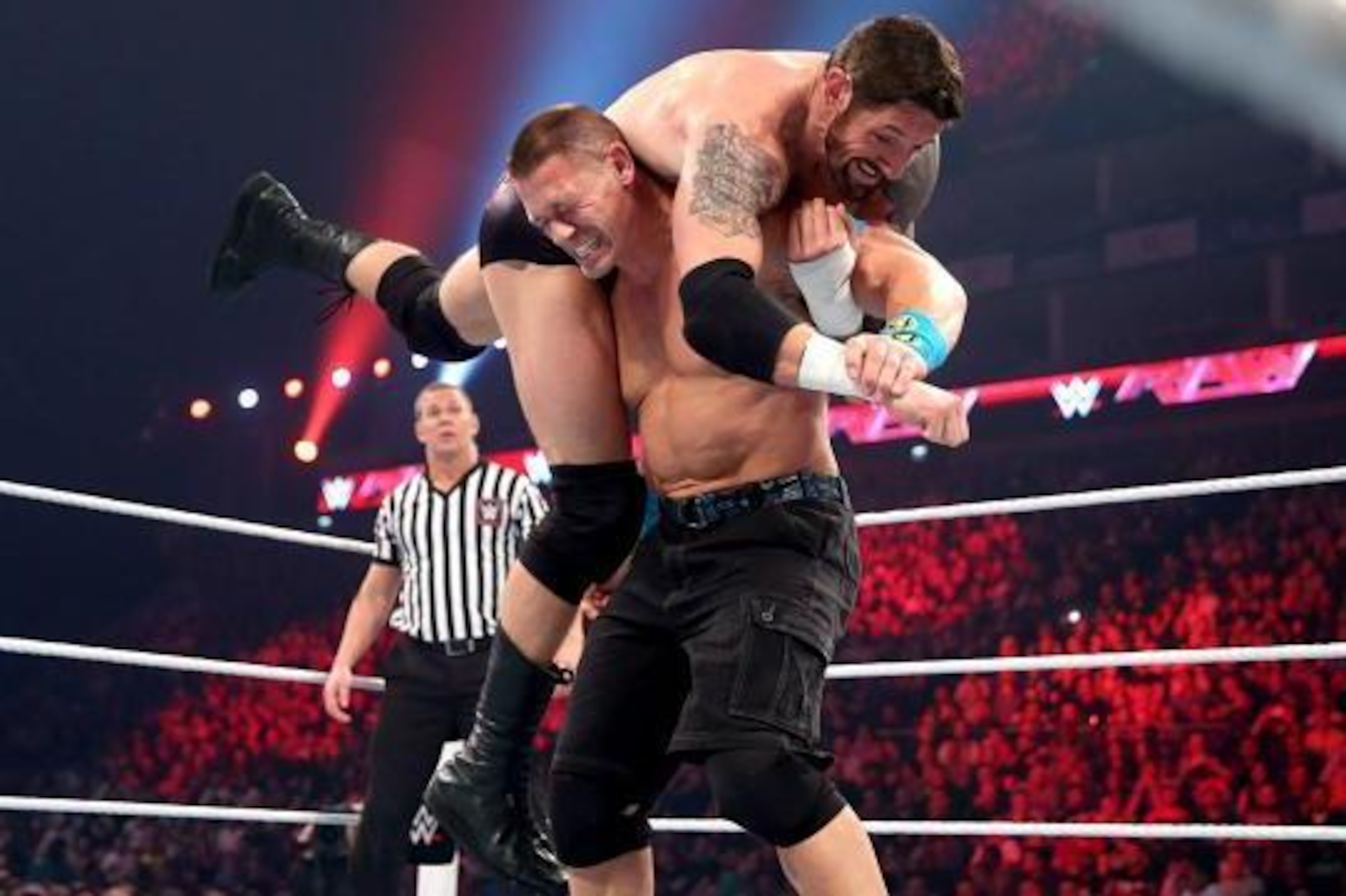John Cena lifts King Barrett for an Attitude Adjustment. John Cena lifts King Barrett for an Attitude Adjustment.