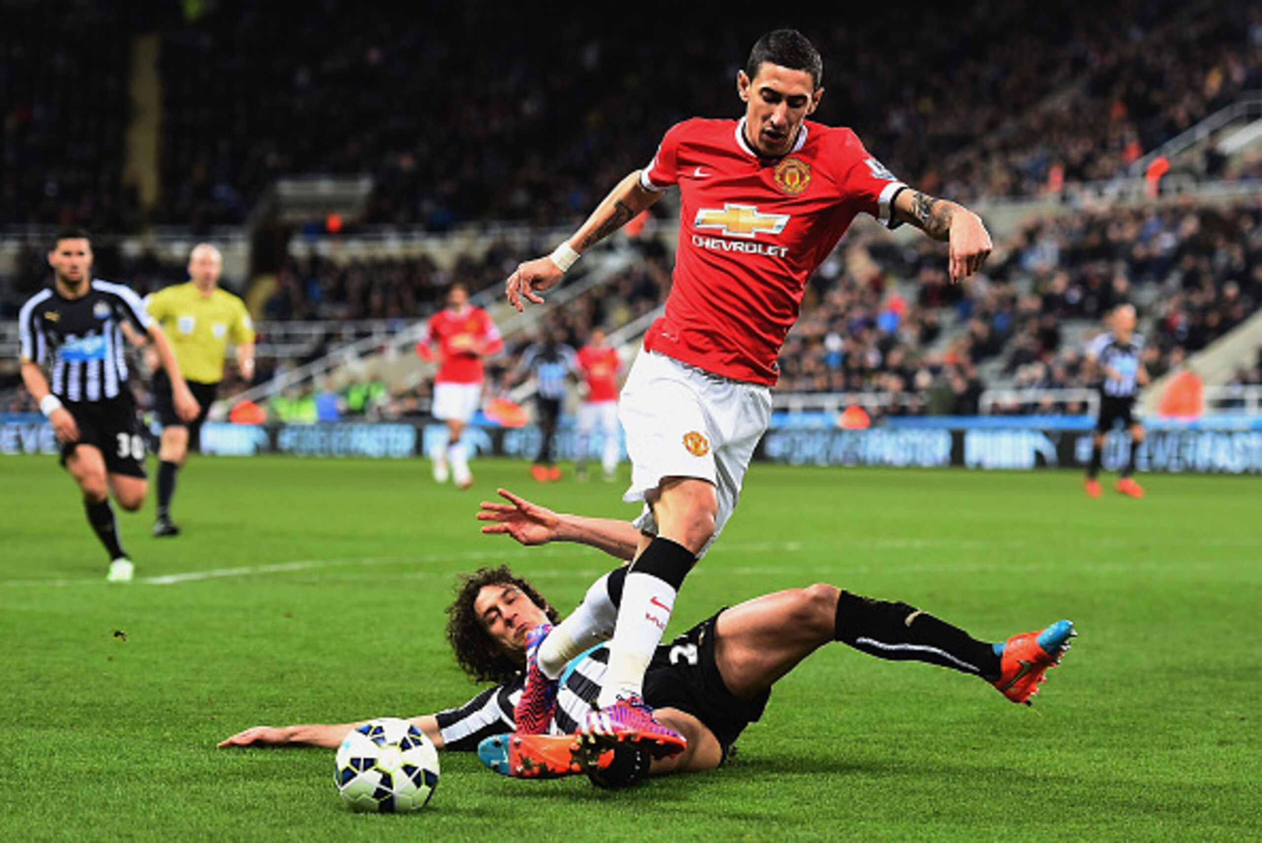 NEWCASTLE UPON TYNE, ENGLAND - MARCH 04: Fabricio Coloccini of Newcastle United tackles Angel di Maria of Manchester United  during the Barclays Premier League match between Newcastle United and Manchester United at St James' Park on March 4, 2015 in Newc