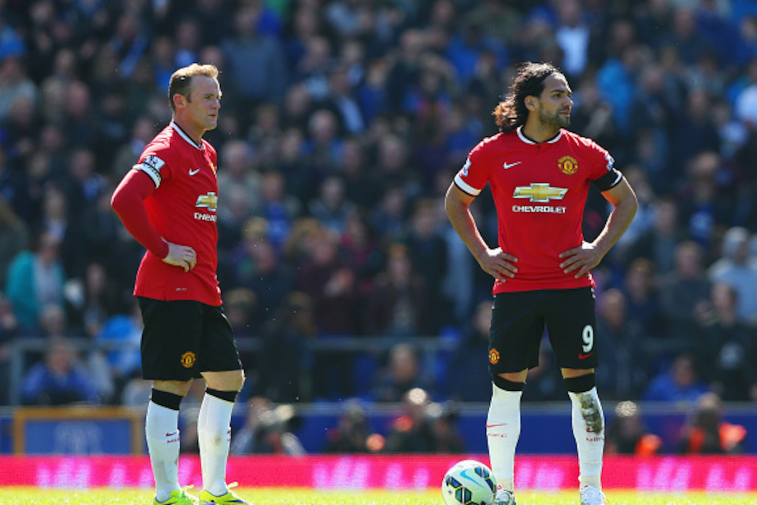LIVERPOOL, ENGLAND - APRIL 26:  Radamel Falcao Garcia (9) and Wayne Rooney of Manchester United look dejected as Kevin Mirallas of Everton scores their third goal during the Barclays Premier League match between Everton and Manchester United at Goodison P