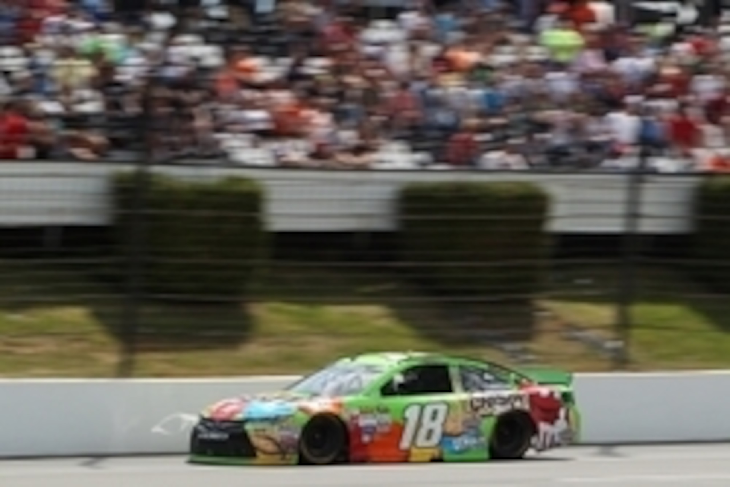Jun 7, 2015; Long Pond, PA, USA; NASCAR Sprint Cup Series driver Kyle Busch (18) races during the Axalta We Paint Winners 400 at Pocono Raceway. Mandatory Credit: Matthew O'Haren-USA TODAY Sports