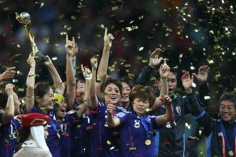 FRANKFURT AM MAIN, GERMANY - JULY 17: Homare Sawa of Japan (L) lifts the winning trophy on the podium after winning 5-3 after penalyts shoot-out the FIFA Women's World Cup Final match between Japan and USA at the FIFA World Cup stadium Frankfurt on July 1