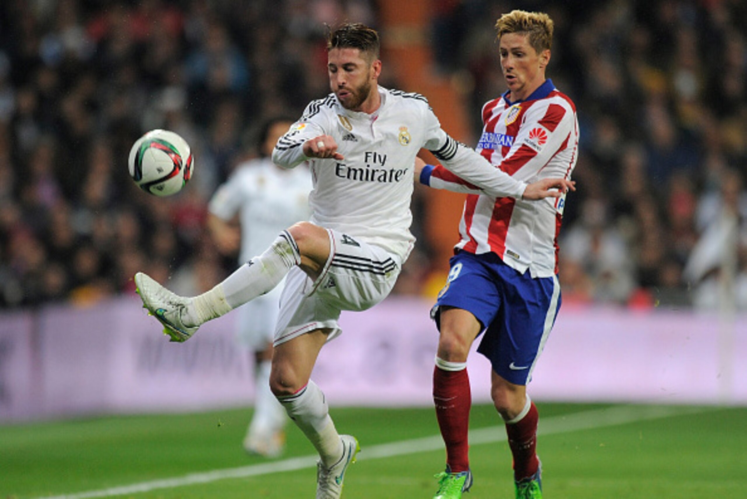 MADRID, SPAIN - JANUARY 15:  Fernando Torres of Atletico de Madrid in action against Sergio Ramos of Real Madrid
during the Copa del Rey Round of 16, Second leg match between Real Madrid and Atletico de Madrid at Estadio Santiago Bernabeu on January 15, 2