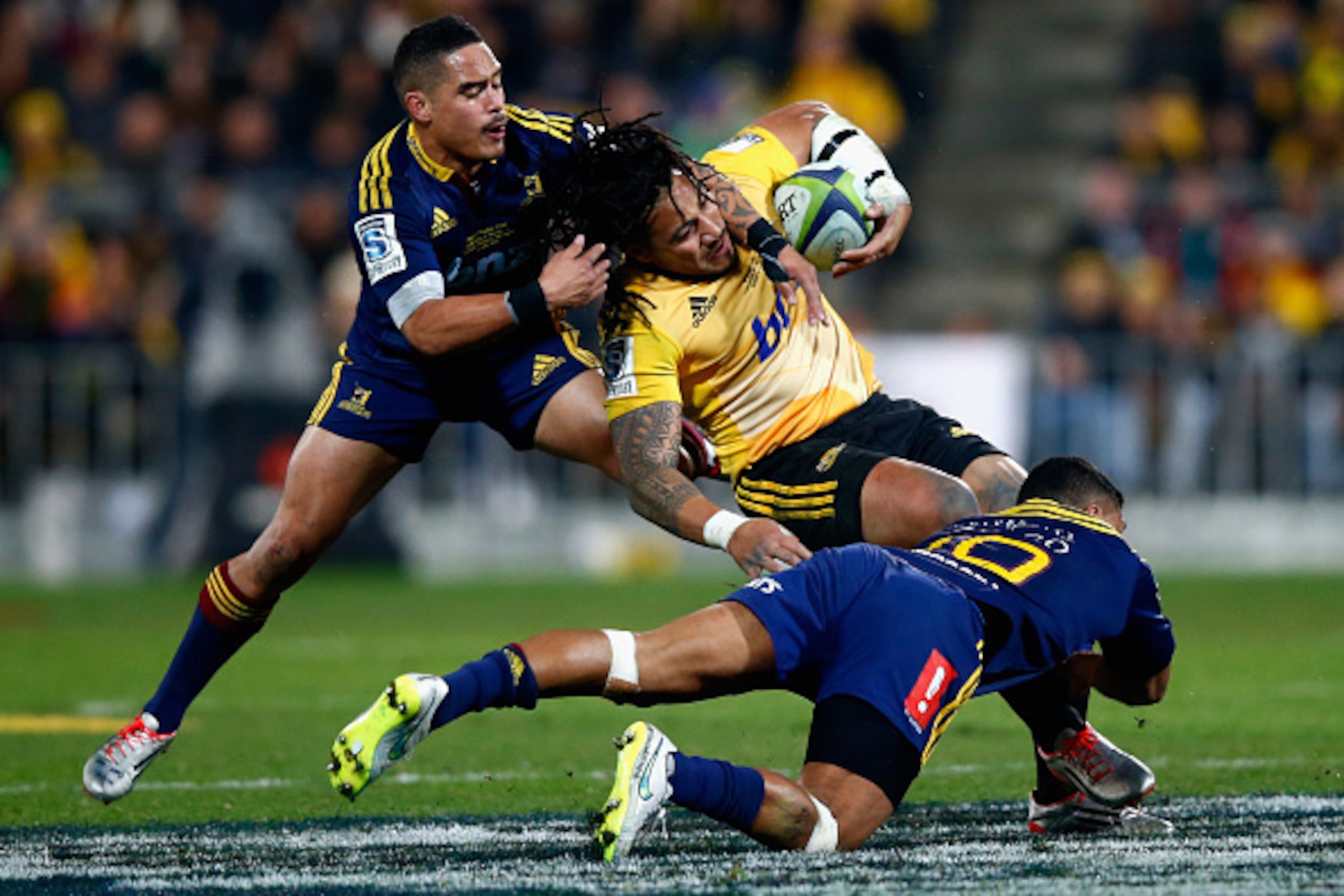 WELLINGTON, NEW ZEALAND - JULY 04: Ma'a Nonu of the Hurricanes is tackled by Aaron Smith and Lima Sopoaga of the Highlanders during the Super Rugby Final match between the Hurricanes and the Highlanders at Westpac Stadium on July 4, 2015 in Wellington, Ne