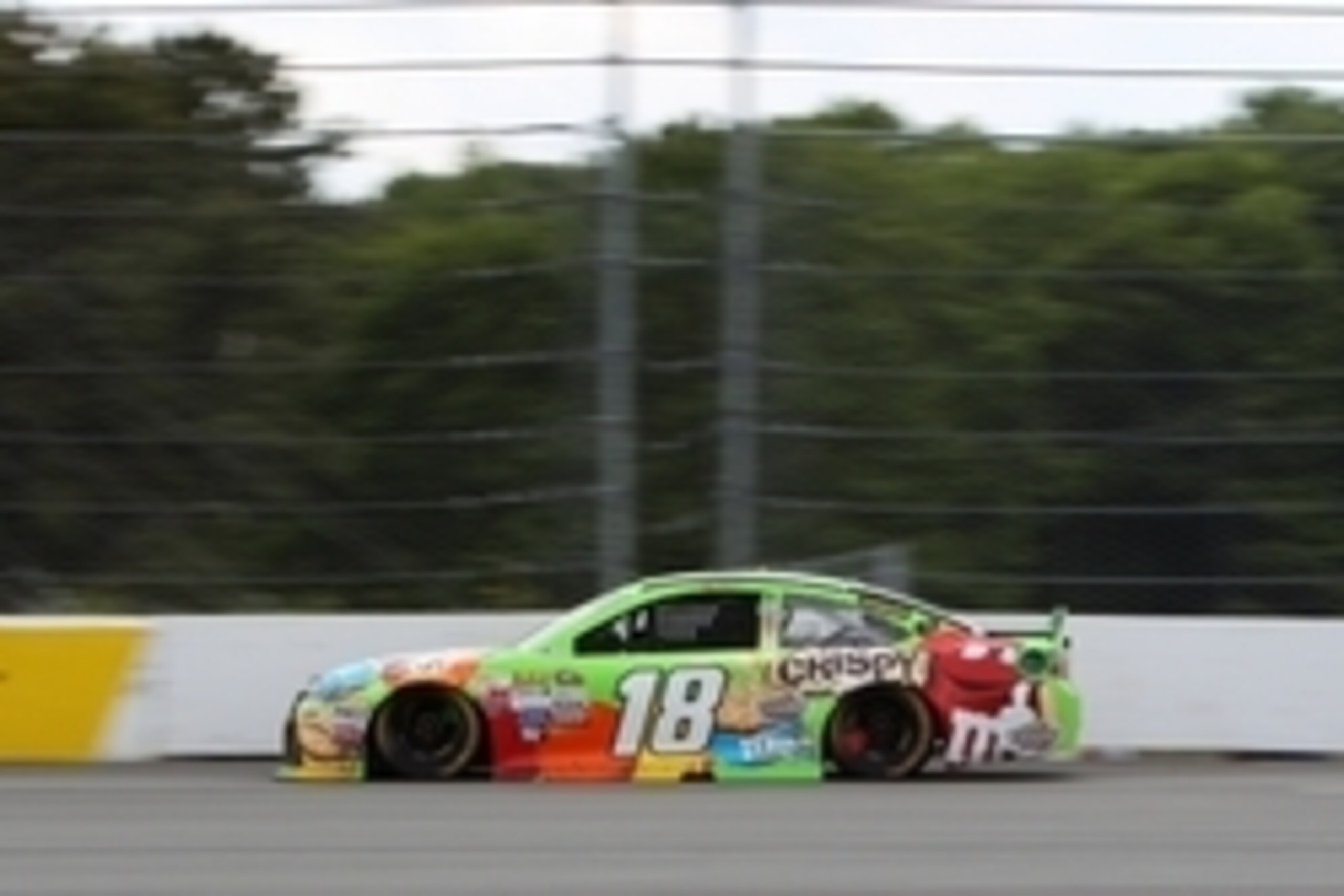 Jun 7, 2015; Long Pond, PA, USA; NASCAR Sprint Cup Series driver Kyle Busch (18) races during the Axalta We Paint Winners 400 at Pocono Raceway. Mandatory Credit: Matthew O'Haren-USA TODAY Sports
