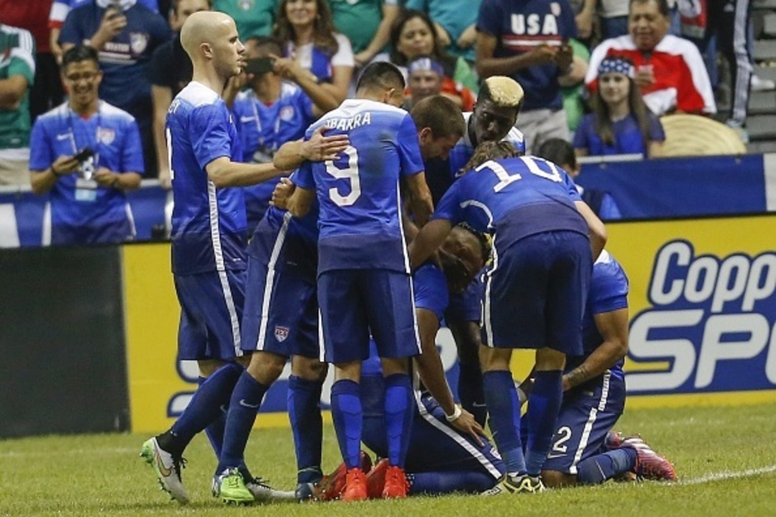 SAN ANTONIO, TX - APRIL 15:  The United States team surround Juan Agudelo #17 after he scores a goal against Mexico during an international friendly match at the Alamodome on April 15, 2015 in San Antonio, Texas.  (Photo by Chris Covatta/Getty Images)