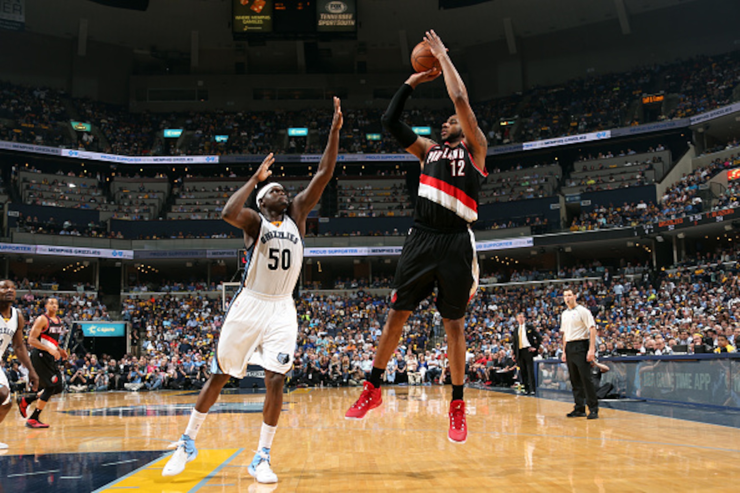 MEMPHIS, TN - APRIL 29: LaMarcus Aldridge #12 of the Portland Trail Blazers shoots against Zach Randolph #50 of the Memphis Grizzlies in Game Five of the Western Conference Quarterfinals of the NBA Playoffs at FedExForum on April 29, 2015 in Memphis, Tenn