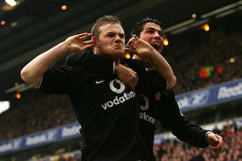 LIVERPOOL, ENGLAND - JANUARY 15:  Wayne Rooney and team mate Cristiano Ronaldo of Manchester United respond to Liverpool fans after Rooney scored during the Barclays Premiership match between Liverpool and Manchester United at Anfield on January 15, 2005 