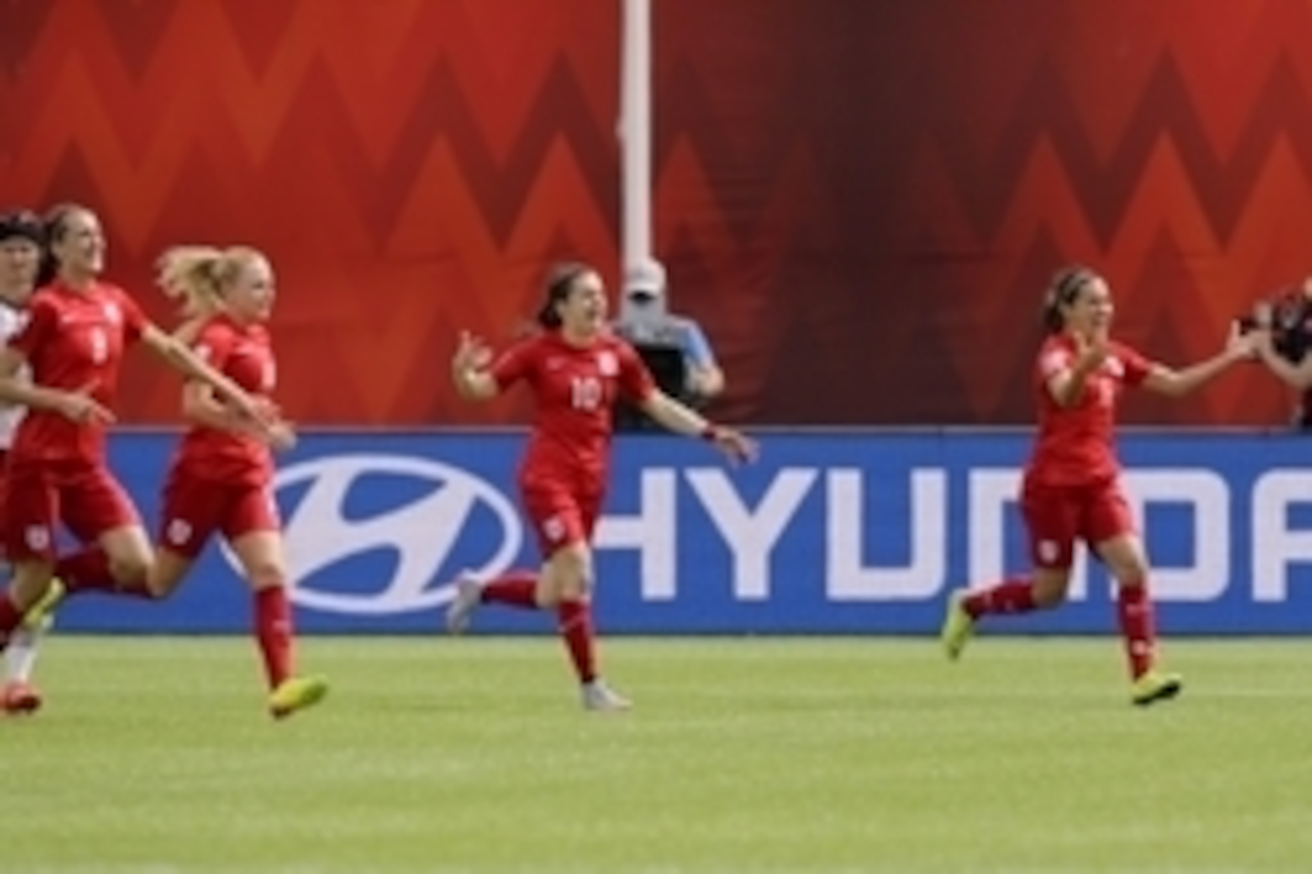 Jul 4, 2015; Edmonton, Alberta, CAN; England midfielder Fara Williams (far right) reacts with teammates after scoring on a penalty kick against  Germany in extra time during the third place match of the FIFA 2015 Women's World Cup at Commonwealth Stadium.