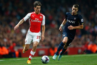 LONDON, ENGLAND - SEPTEMBER 23:  Hector Bellerin of Arsenal moves away from Morgan Schneiderlin of Southampton during the Capital One Cup Third Round match between Arsenal and Southampton at the Emirates Stadium on September 23, 2014 in London, England.  
