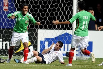 EAST RUTHERFORD, NJ - JULY 26:  Giovani Dos Santos #17 and Carlos Vela #11 of Mexico celebrate Dos Santos' goal in front of Jay Heaps #16 of the United States in the CONCACAF Gold Cup Championship match at Giants Stadium on July 26, 2009 in East Rutherfor