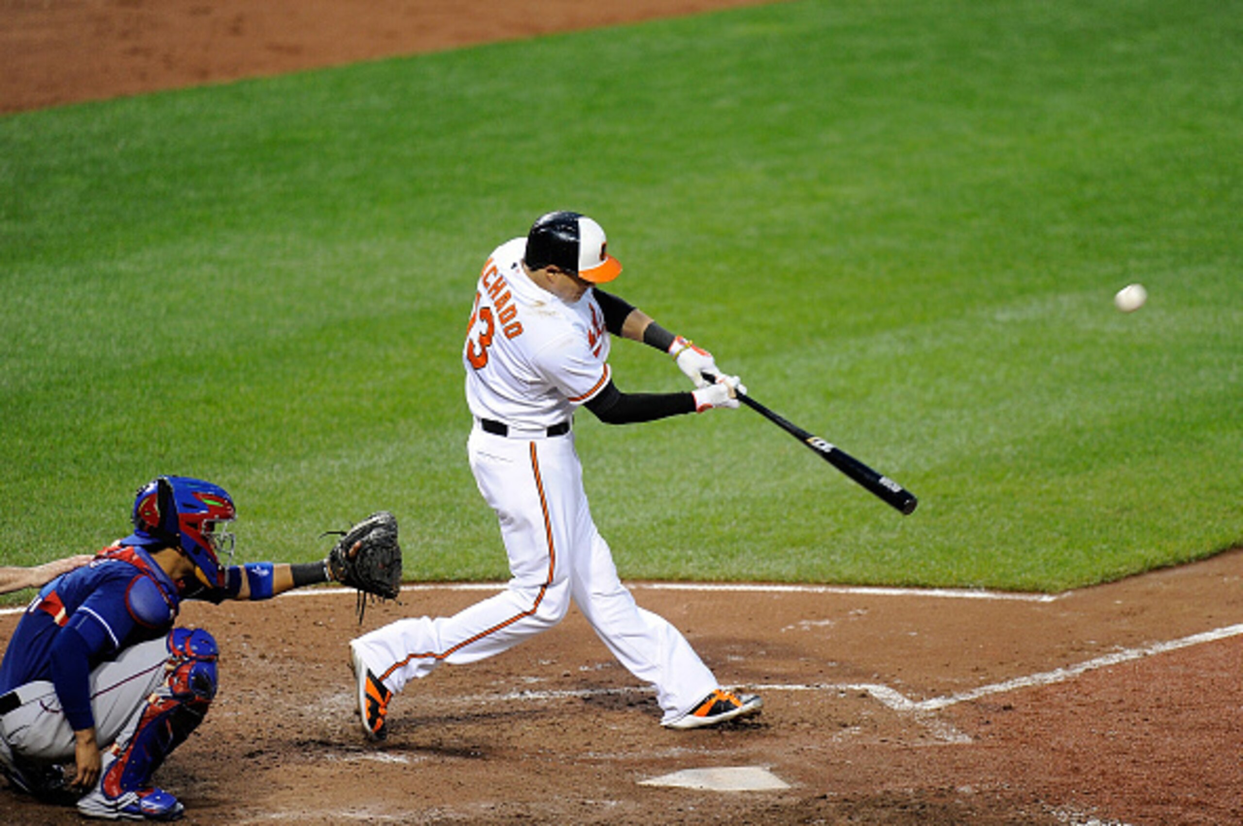 BALTIMORE, MD - JUNE 30:  Manny Machado #13 of the Baltimore Orioles hits a home run in the fifth inning against the Texas Rangers at Oriole Park at Camden Yards on June 30, 2015 in Baltimore, Maryland.  (Photo by Greg Fiume/Getty Images)