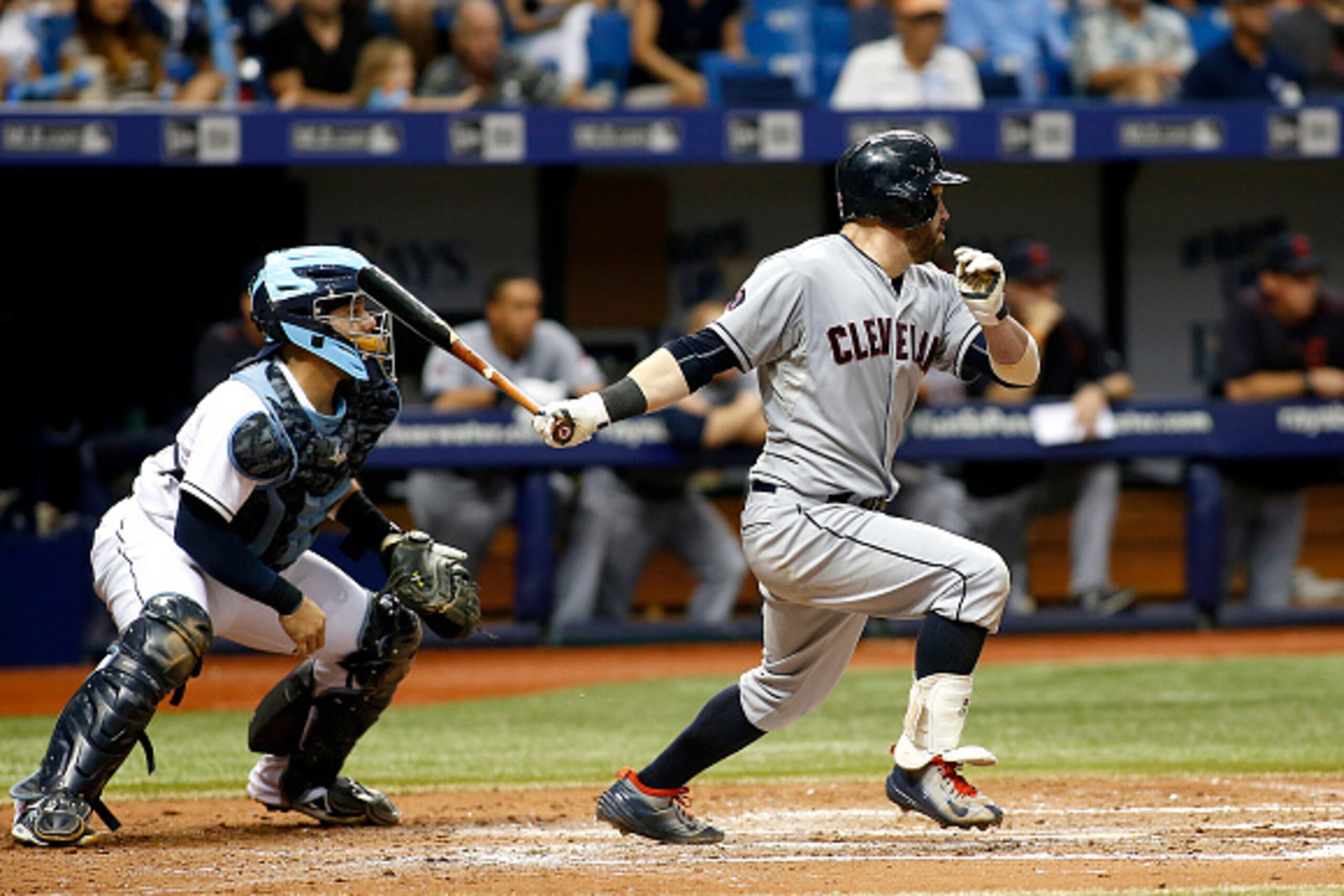 ST. PETERSBURG, FL - JULY 2:  Jason Kipnis #22 of the Cleveland Indians hits an RBI single in front of catcher Rene Rivera #44 of the Tampa Bay Rays to score Giovanny Urshela #39 during the fifth inning of a game on July 2, 2015 at Tropicana Field in St. 
