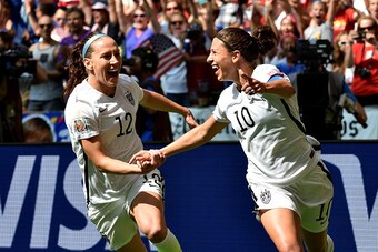 VANCOUVER, BC - JULY 05:  Lauren Holiday #12 and Carli Lloyd #10 of the United States celebrate with teammates after Lloyd scores her second goal against Japan in the FIFA Women's World Cup Canada 2015 Final at BC Place Stadium on July 5, 2015 in Vancouve