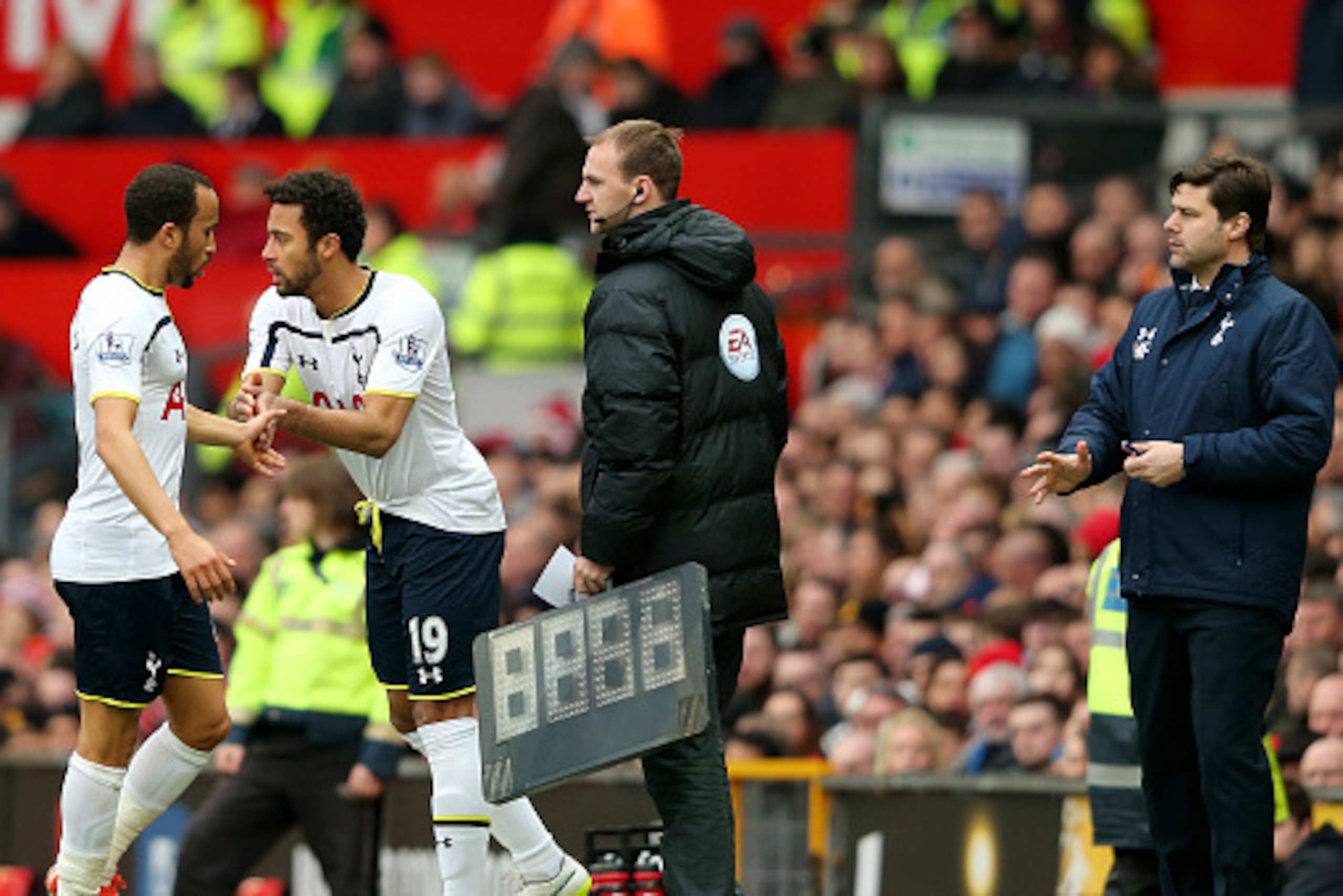 MANCHESTER, ENGLAND - MARCH 15: Manager Mauricio Pochettino of Spurs sends on Mousa Dembele of Spurs as a first half substitute for the beleaguered Andros Townsend of Spurs  during the Barclays Premier League match between Manchester United and Tottenham