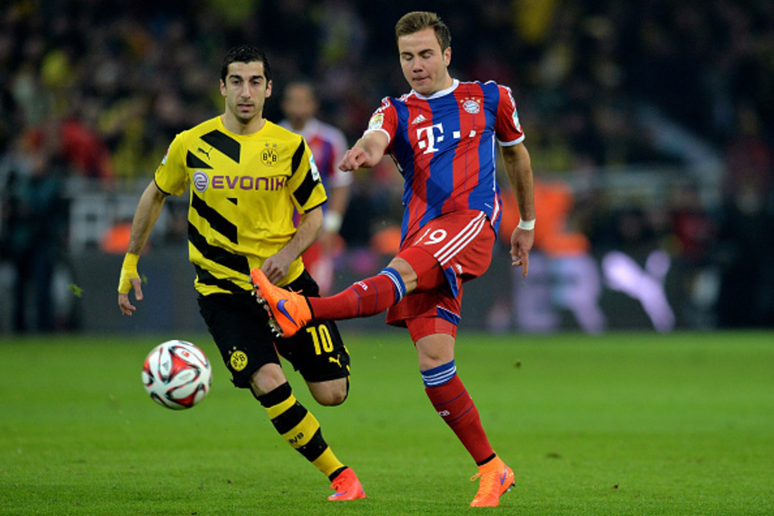 DORTMUND, GERMANY - APRIL 04:  (L-R) Henrikh Mkhitaryan of Dortmund vies with Mario Goetze of Muenchen during the Bundesliga match between Borussia Dortmund and FC Bayern Muenchen at Signal Iduna Park on April 4, 2015 in Dortmund, Germany.  (Photo by Sasc