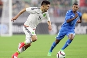Jul 1, 2015; Houston, TX, USA; Mexico forward Oribe Peralta (19) dribbles the ball against Honduras midfielder Brayan Acosta (6) in the second half during a soccer match at NRG Stadium. Mandatory Credit: Thomas B. Shea-USA TODAY Sports