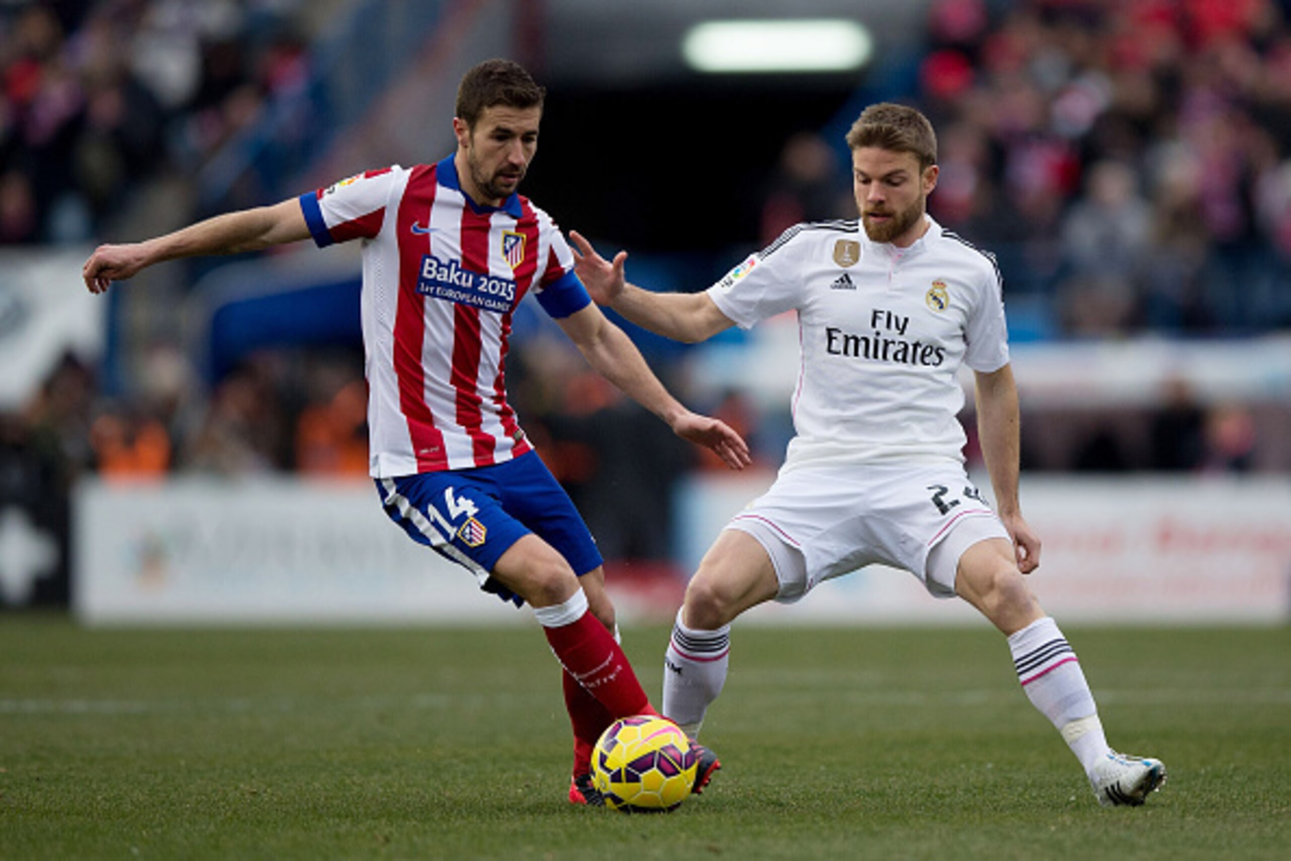 MADRID, SPAIN - FEBRUARY 07: Gabi Fernandez (L) of Atletico de Madrid competes for the ball with Asier Illarramendi (R) of Real Madrid CF during the La Liga match between Club Atletico de Madrid and Real Madrid CF at Vicente Calderon Stadium on February 7 MADRID, SPAIN - FEBRUARY 07: Gabi Fernandez (L) of Atletico de Madrid competes for the ball with Asier Illarramendi (R) of Real Madrid CF during the La Liga match between Club Atletico de Madrid and Real Madrid CF at Vicente Calderon Stadium on February 7