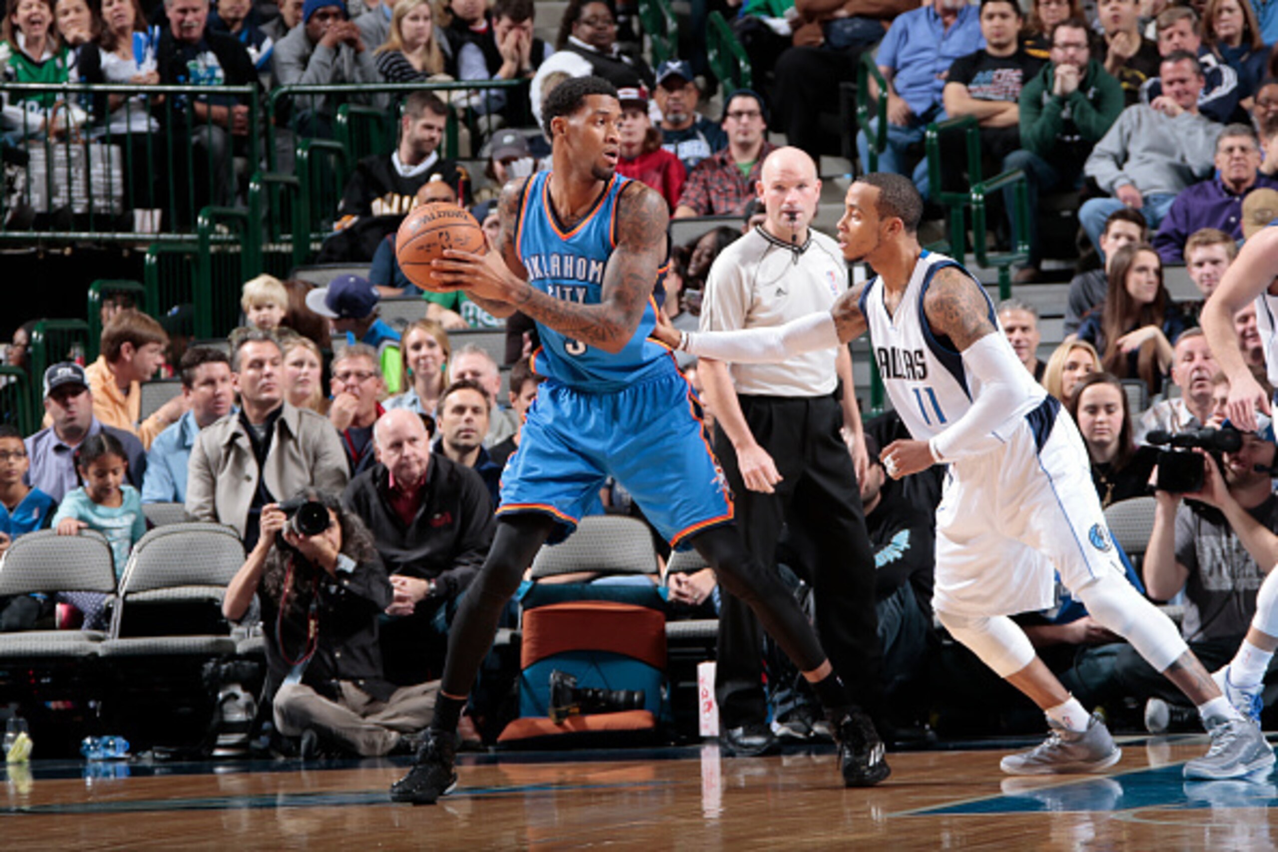 DALLAS, TX - DECEMBER 28: Perry Jones #3 of the Oklahoma City Thunder posts up against Monta Ellis #11 of the Dallas Mavericks on December 28, 2014 at the American Airlines Center in Dallas, Texas. NOTE TO USER: User expressly acknowledges and agrees that