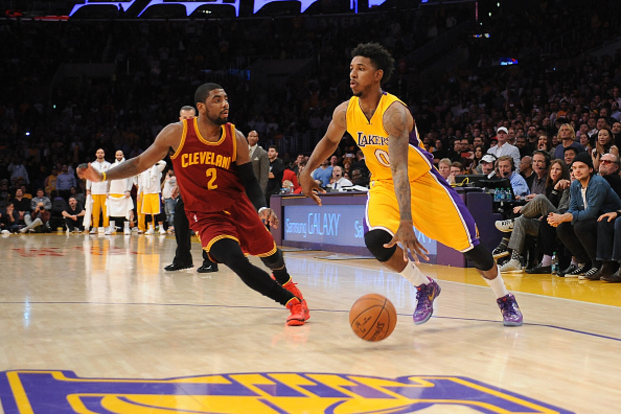 LOS ANGELES, CA - JANUARY 15: Nick Young #0 of the Los Angeles Lakers drives against Kyrie Irving #2 of the Cleveland Cavaliers at STAPLES Center on January 15, 2015 in Los Angeles, California. NOTE TO USER: User expressly acknowledges and agrees that, by