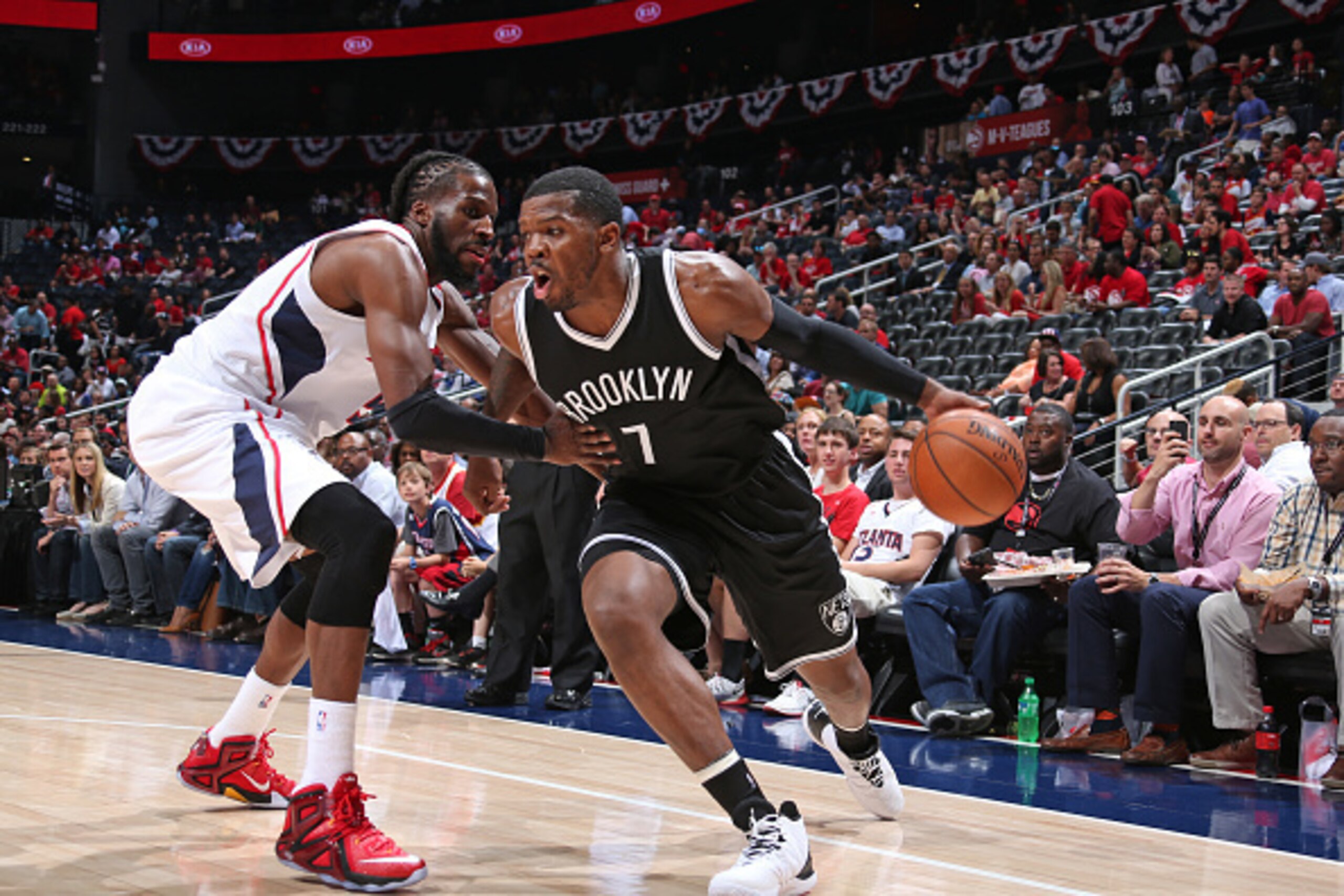 ATLANTA, GA - APRIL 22:  Joe Johnson #7 of the Brooklyn Nets drives to the basket against DeMarre Carroll #5 of the Atlanta Hawks in Game Two of the Eastern Conference Quarterfinals during the 2015 NBA Playoffs on April 22, 2015 at Philips Arena in Atlant