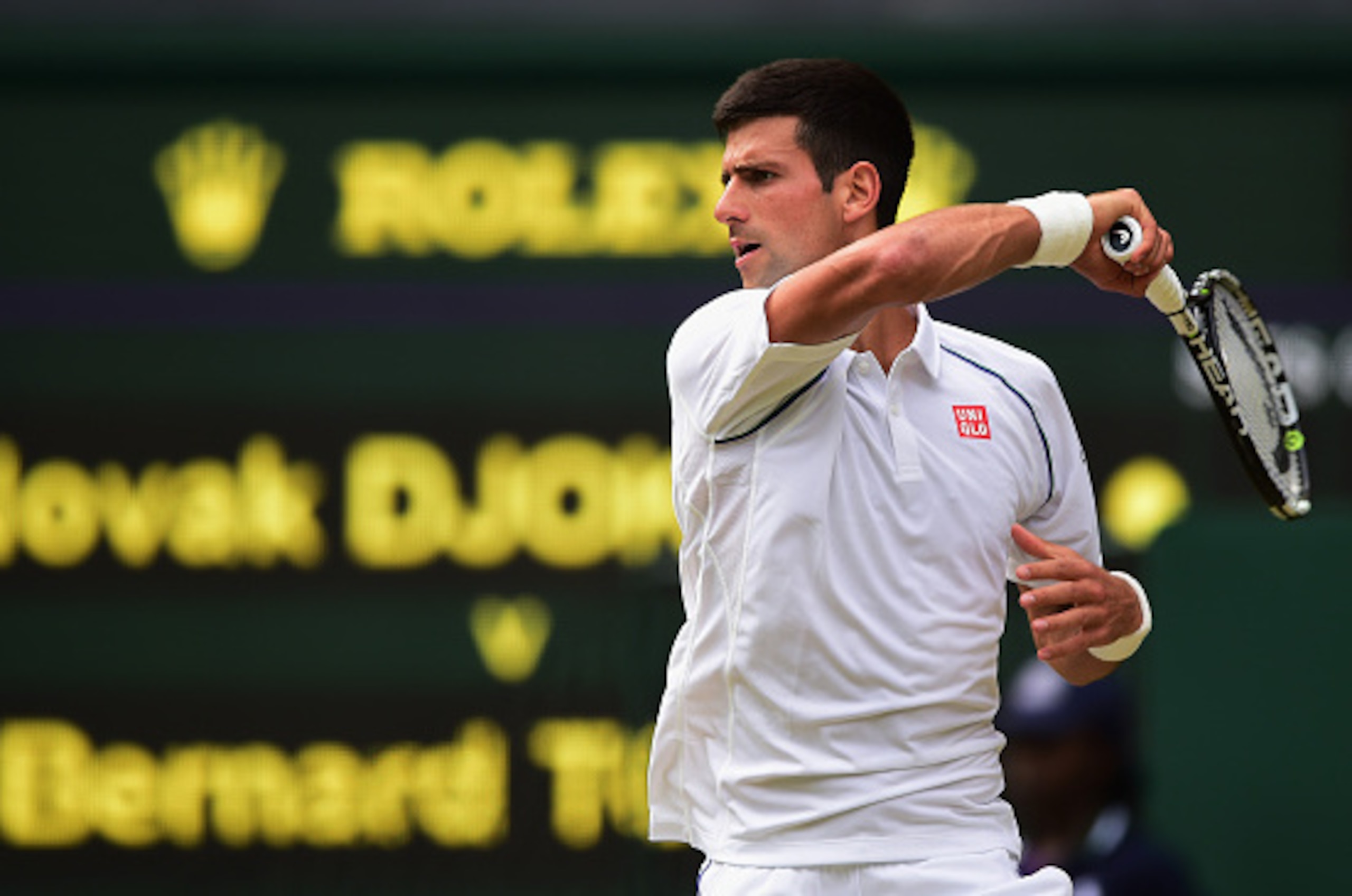 LONDON, ENGLAND - JULY 03:  Novak Djokovic of Serbia plays a forehand in his Gentlemen's Singles Third Round match against Bernard Tomic of Australia during day five of the Wimbledon Lawn Tennis Championships at the All England Lawn Tennis and Croquet Clu