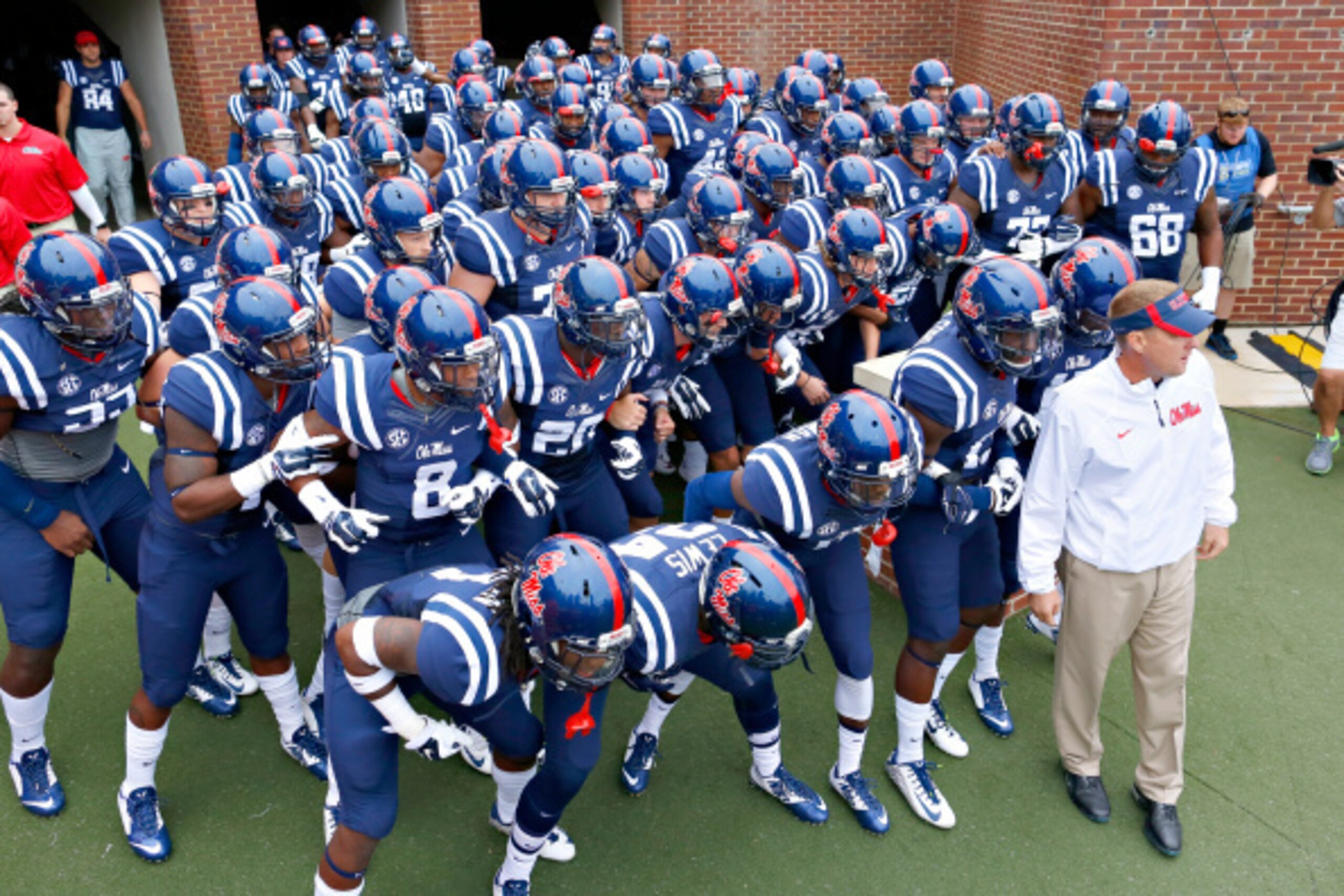 OXFORD, MS - SEPTEMBER 13:  The Ole Miss Rebels and Head Coach Hugh Freeze prepare to run onto the field before a game against the Louisiana-Lafayette Ragin' Cajuns at Vaught-Hemingway Stadium on September 13, 2014 in Oxford, Mississippi.  (Photo by Wesle