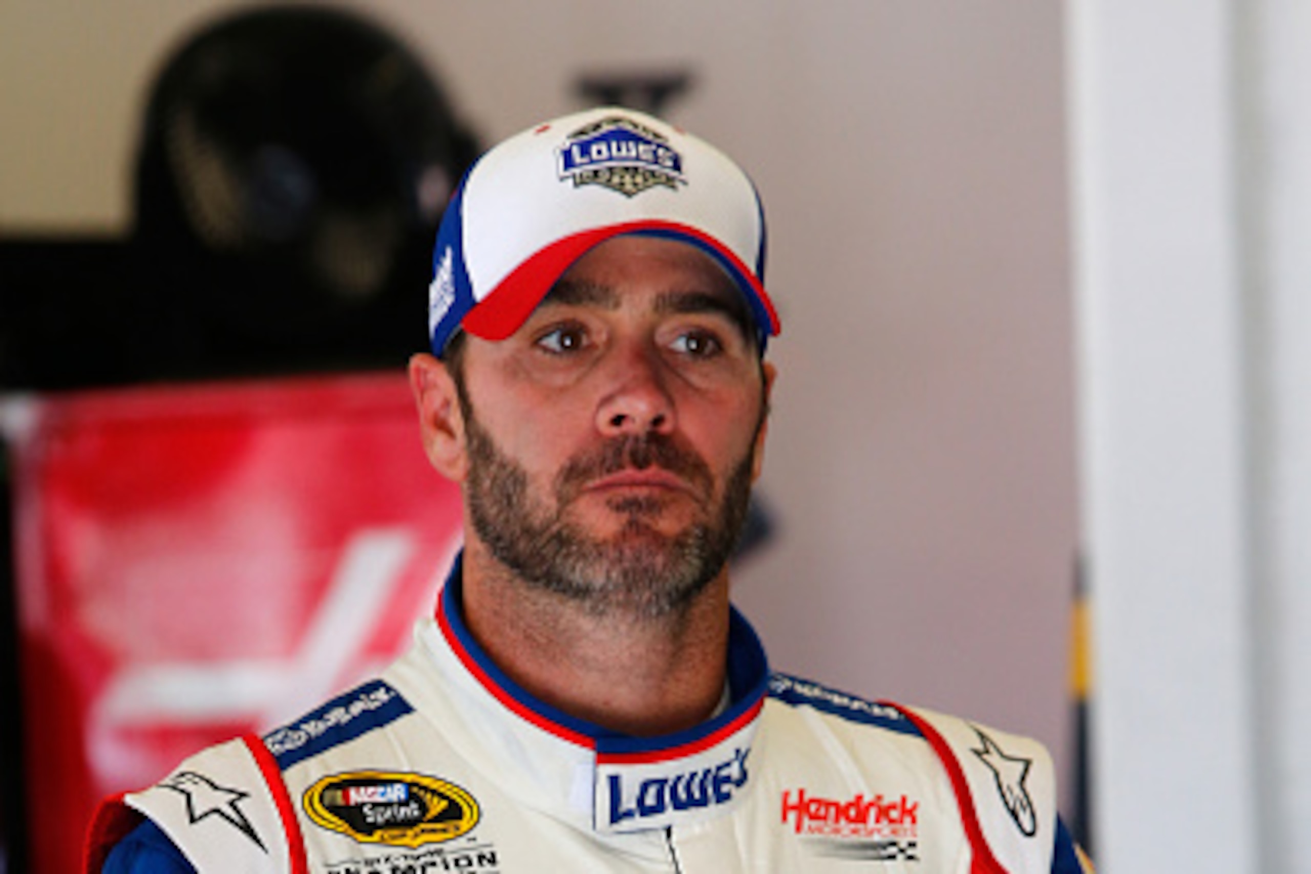 DAYTONA BEACH, FL - JULY 03:  Jimmie Johnson, driver of the #48 Lowe's Patriotic Chevrolet, stands in the garage area during practice for the NASCAR Sprint Cup Series Coke Zero 400 at Daytona International Speedway on July 3, 2015 in Daytona Beach, Florid