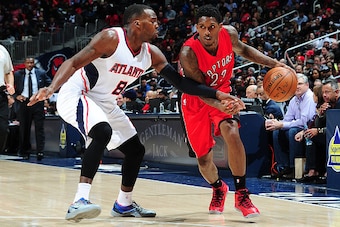 ATLANTA, GA - FEBRUARY 20: Lou Williams #23 of the Toronto Raptors drives against Shelvin Mack #8 of the Atlanta Hawks on February 20, 2015 at Philips Arena in Atlanta, Georgia.  NOTE TO USER: User expressly acknowledges and agrees that, by downloading an