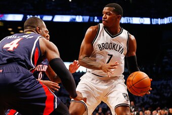 NEW YORK, NY - MAY 01:  Joe Johnson #7 of the Brooklyn Nets looks to make a play as he is defended by Paul Millsap #4 and Jeff Teague #0 of the Atlanta Hawks during game six in the first round of the 2015 NBA Playoffs at Barclays Center on May 1, 2015 in 
