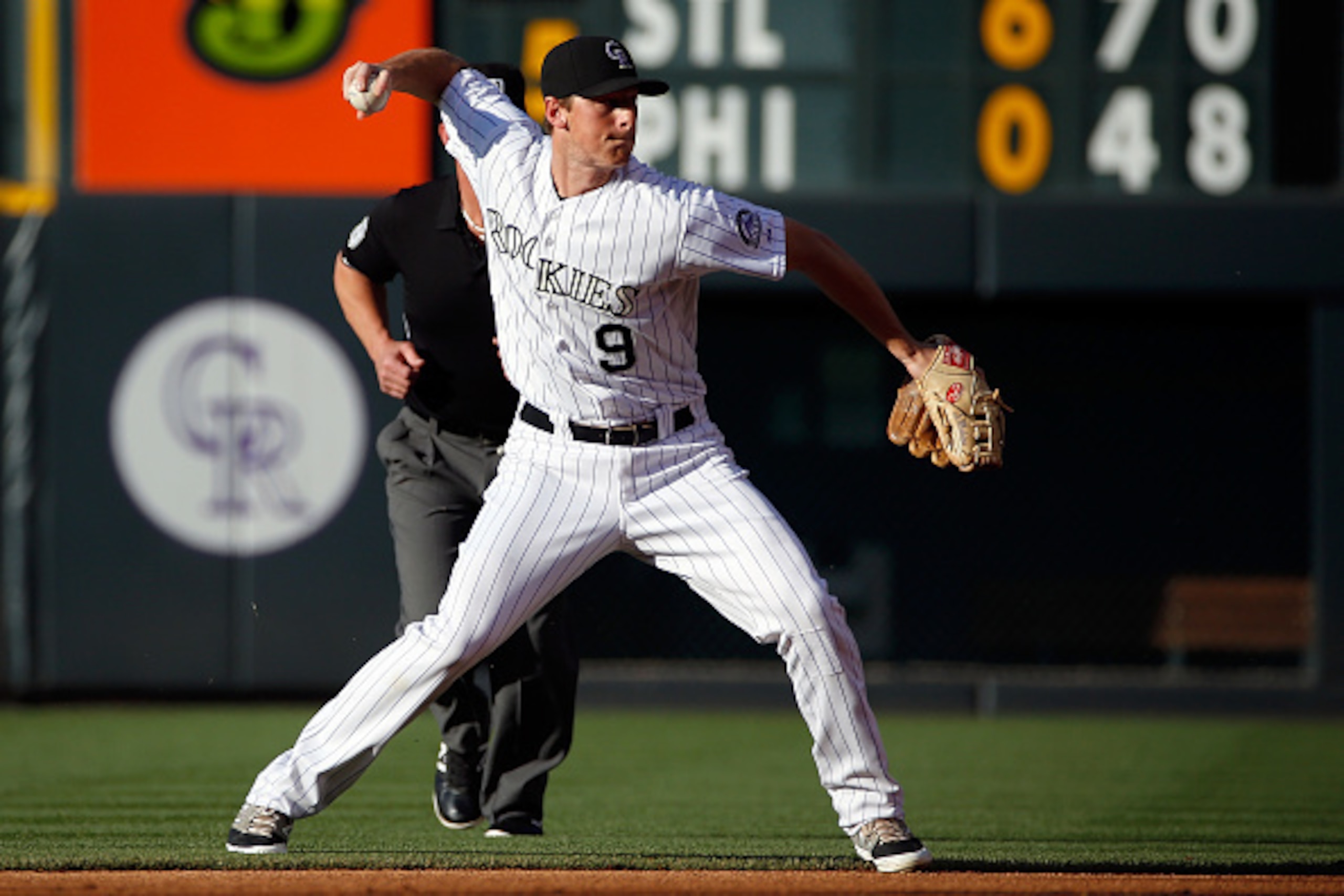 DENVER, CO - JUNE 19:  Second baseman DJ LeMahieu #9 of the Colorado Rockies throws out a runner against the Milwaukee Brewers at Coors Field on June 19, 2015 in Denver, Colorado. The Brewers defeated the Rockies 9-5.  (Photo by Doug Pensinger/Getty Image