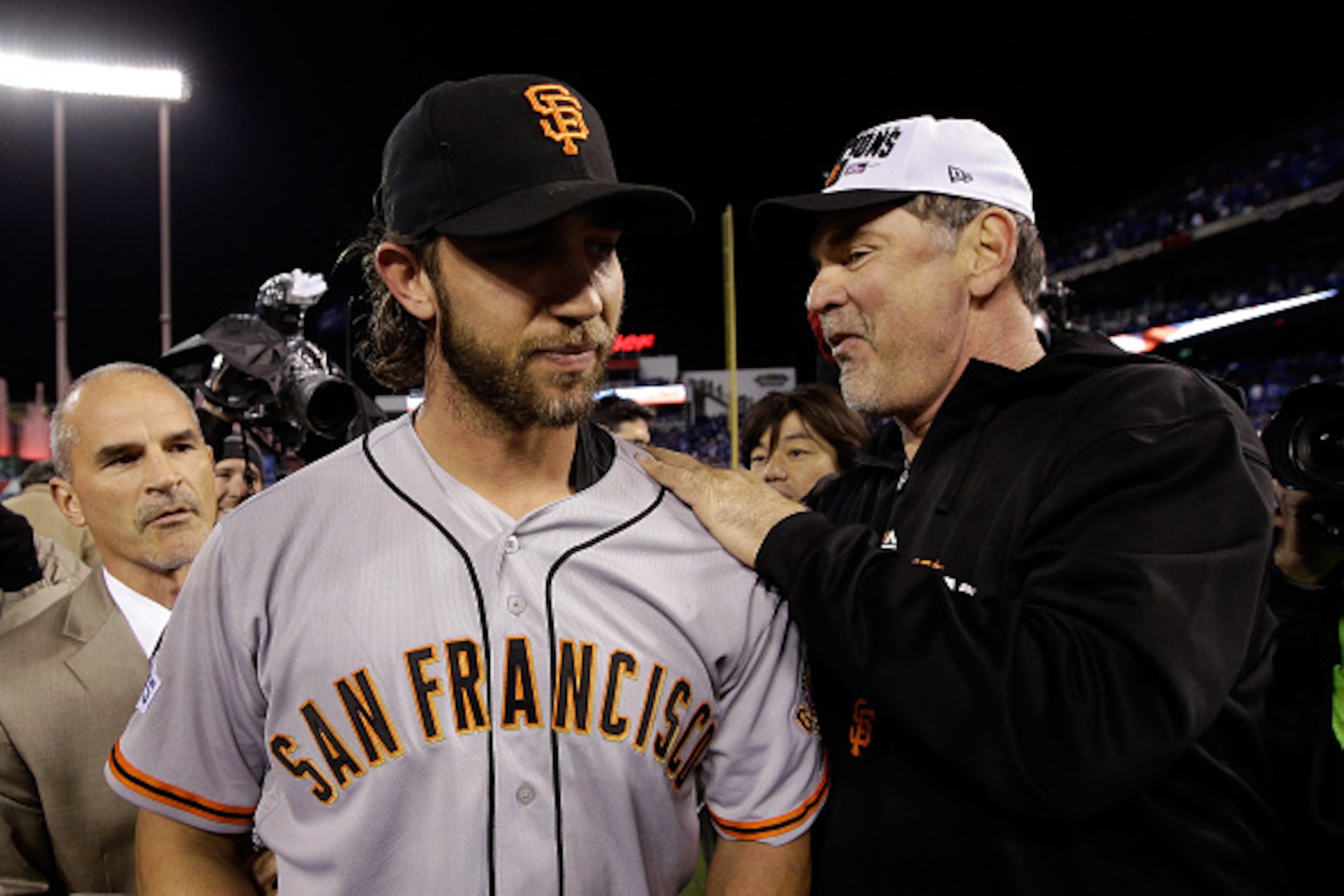 KANSAS CITY, MO - OCTOBER 29:  Manager Bruce Bochy #15 of the San Francisco Giants celebrates on the field with Madison Bumgarner #40 after defeating the Kansas City Royals 3-2 to win Game Seven of the 2014 World Series at Kauffman Stadium on October 29, 